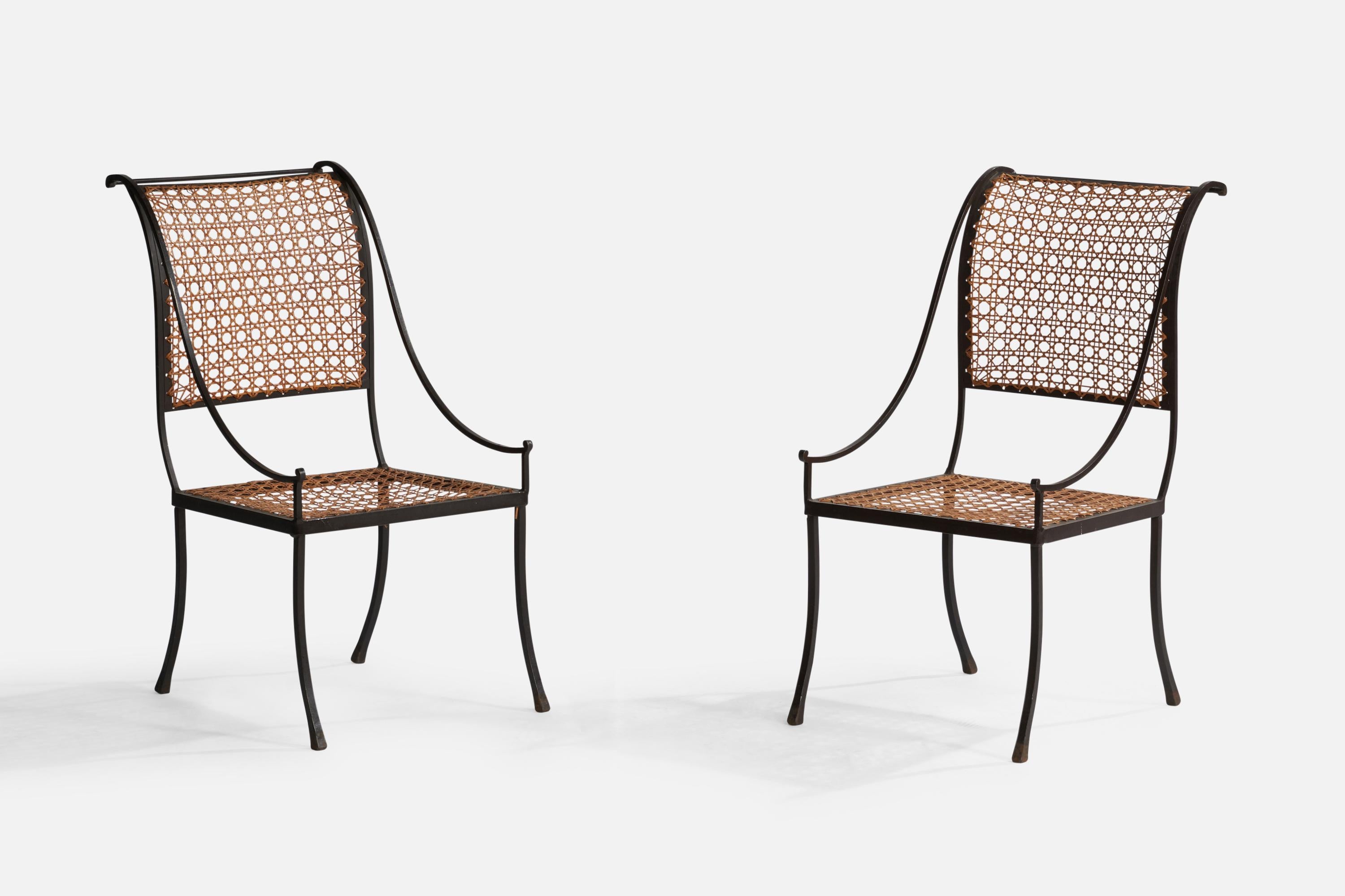 A pair of wrought iron and cane side chairs designed by John Vesey and produced by John Vesey, Inc. circa 1958.