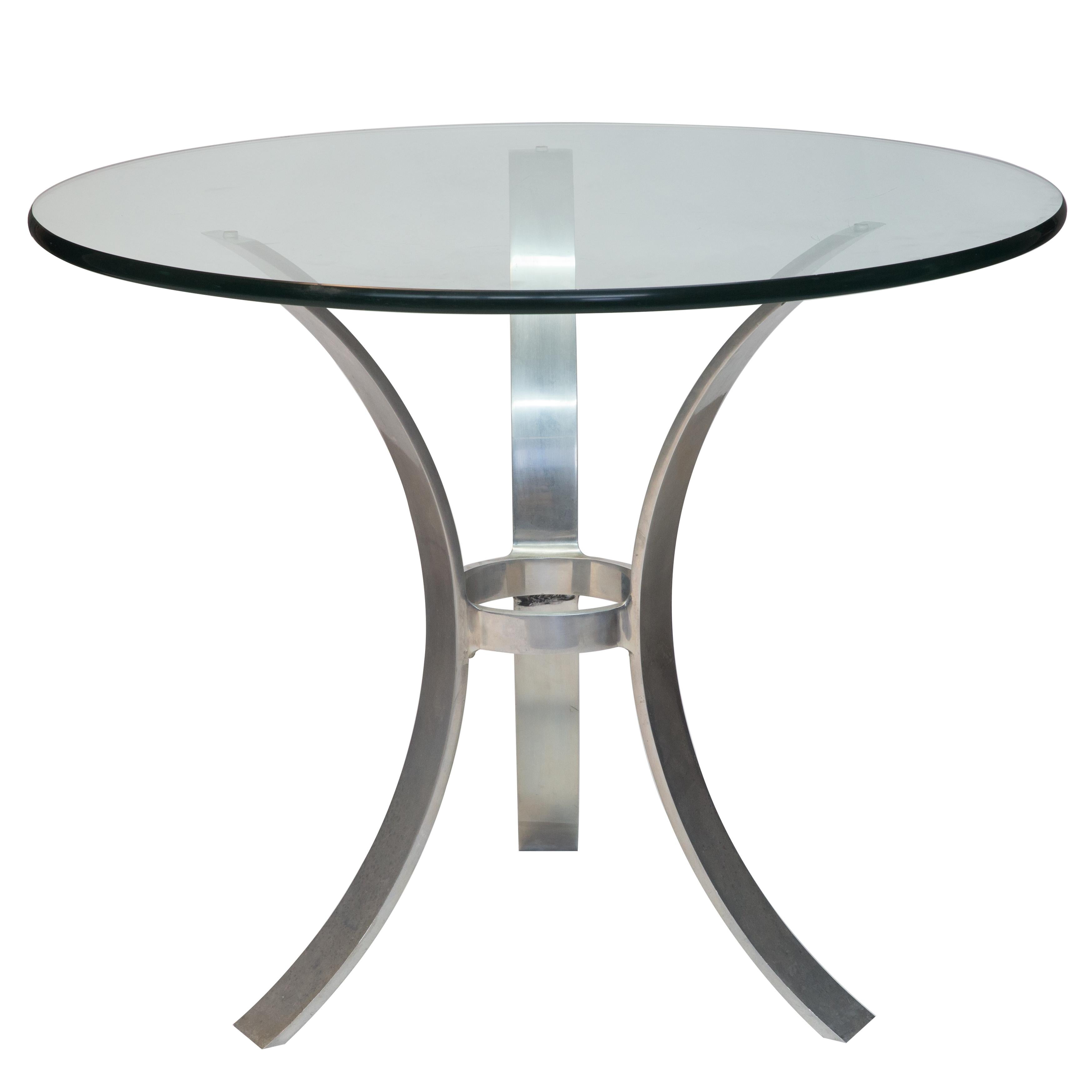 Offered is a John Vesey midcentury classic design round glass top table supported by a tripod polished aluminum base. Modernist furniture by American designer John Vesey has become very, very collectible in recent years. While Vesey began his career