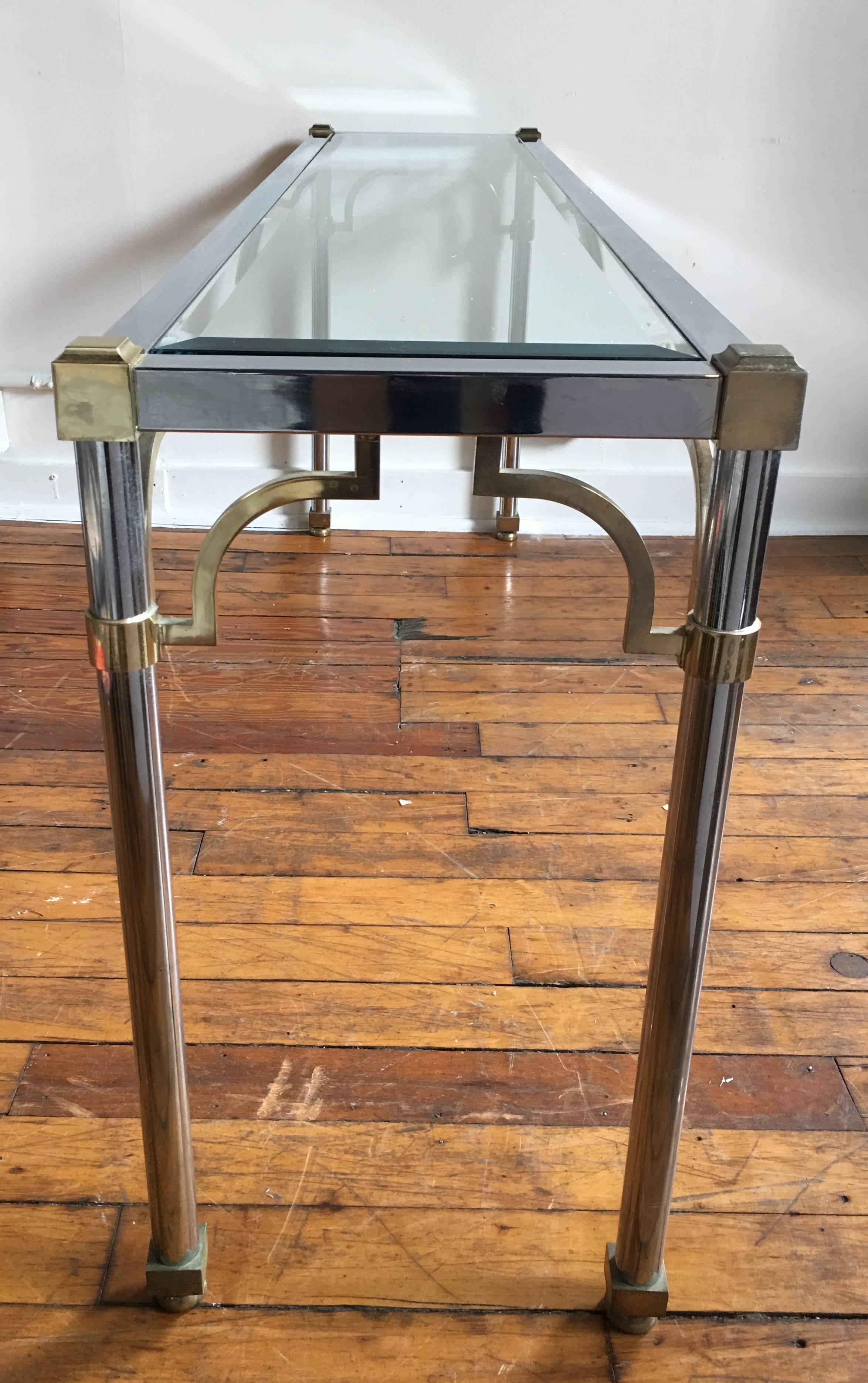Mid-Century Modern mixed metal brass and chromed steel console sofa table in the style of John Vesey and Maison Jansen. Removable clear beveled glass top. Coordinating coffee table also available for purchase.