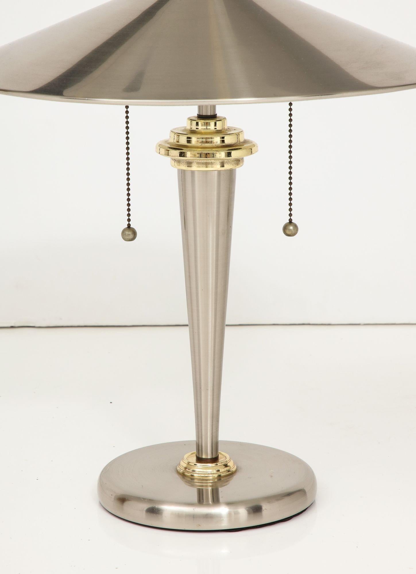 A designer lamp by John Vesey. A stylish nickel plated design and shade with brass accents. . Two lights  with original pulls.