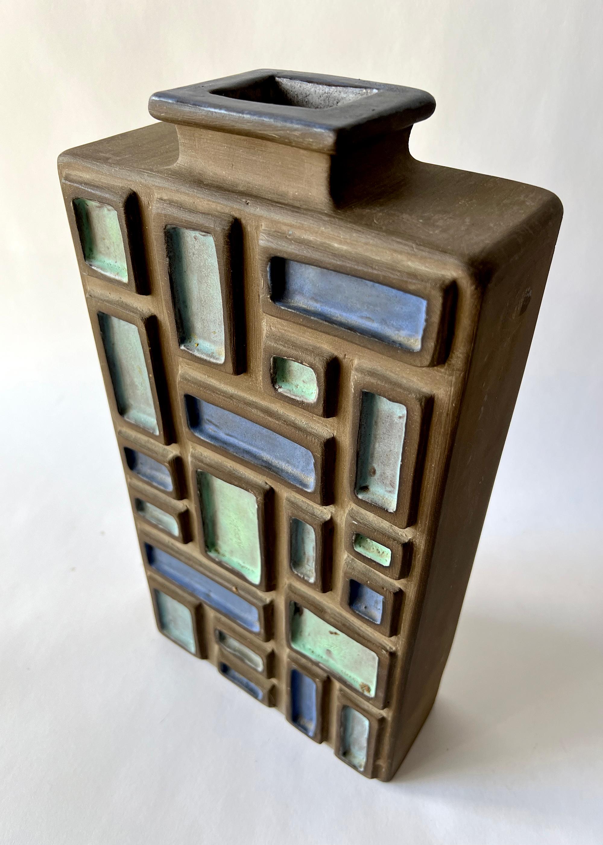 Large scale modernist bottle vase created by John W. Delaplane of Indianapolis, Indiana, circa 1966. Bottle is made of a dark, bisque clay body and decorated with mosaic geometric shapes in blue and light green on the front side only. Signed with a