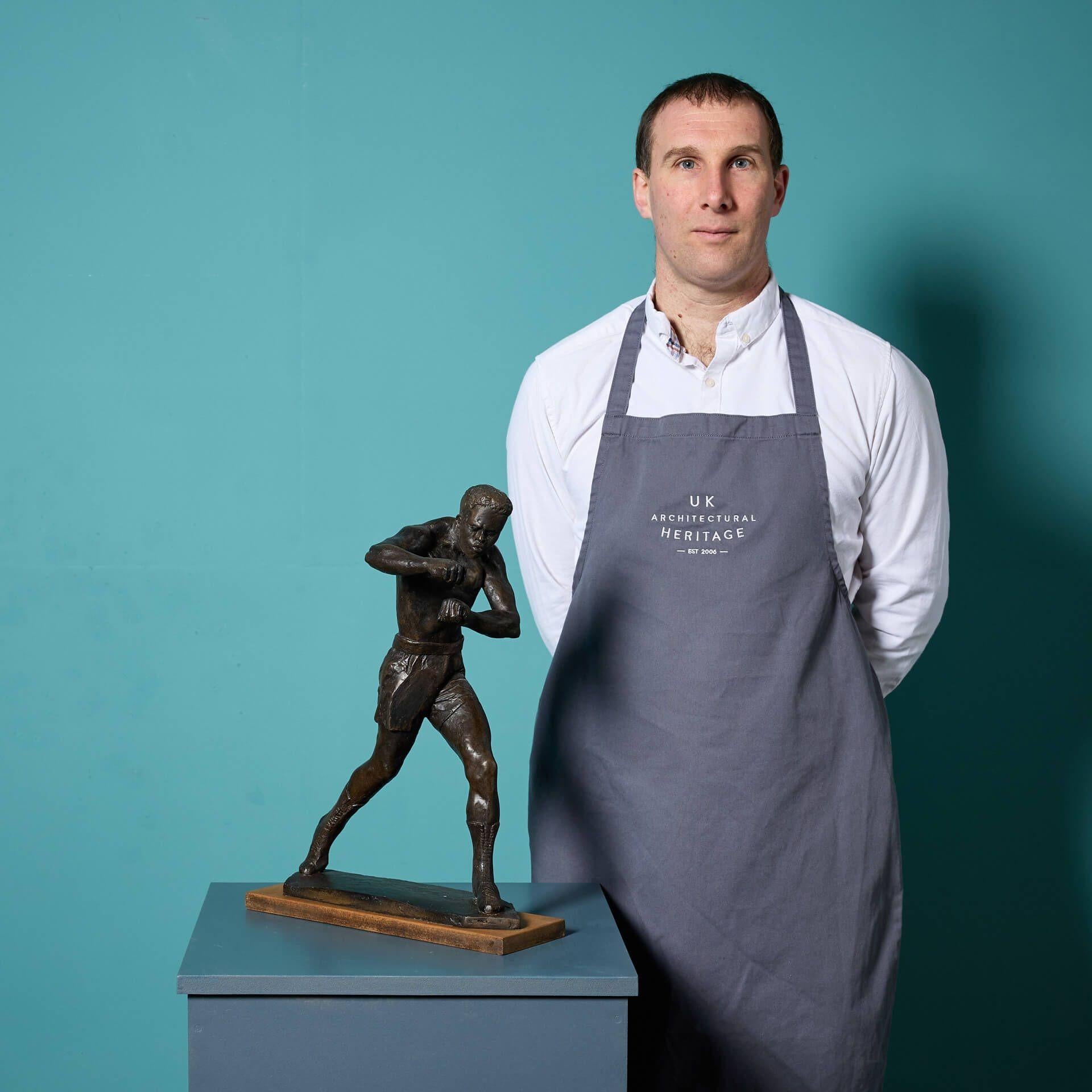 A cold cast bronze figural sculpture titled 'Boxer #1' by the acclaimed British sculptor, John W. Mills.

This three-dimensional dynamic piece creates a sense of movement, demonstrating the talent of its artist. The boxer's posture is captured in