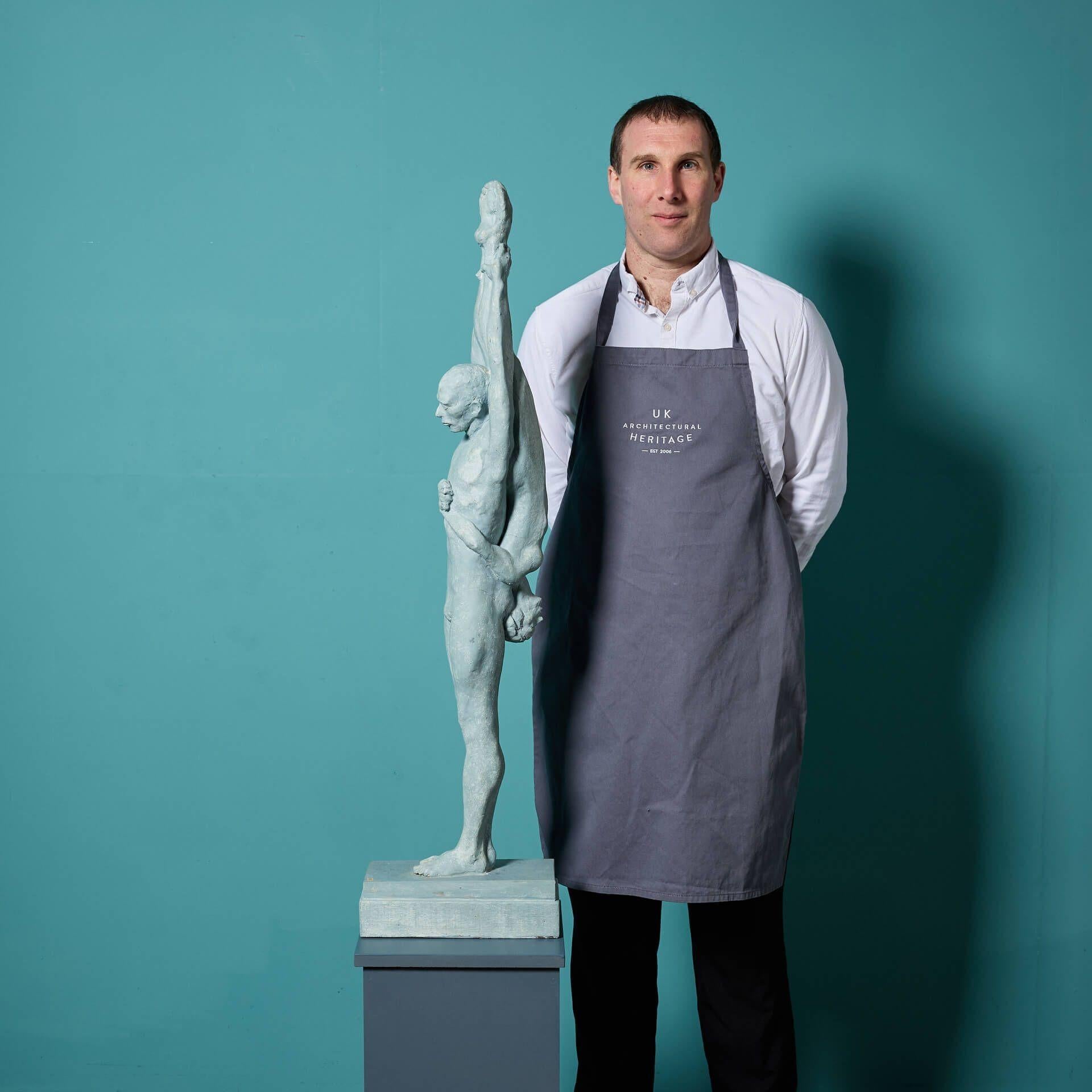 A patinated resin sculpture titled ’Dancers - Female Inverted’ by the acclaimed British sculptor, John W. Mills, stood on a rectangular wooden base.

As a part of his dancer series, this is a maquette acting as a study for Mills showcasing a male
