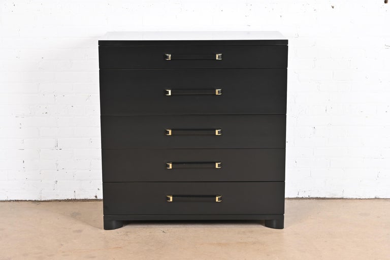 A gorgeous Art Deco or Mid-Century Modern highboy dresser or chest of drawers

By John Widdicomb

USA, Circa 1940s

Black lacquered mahogany, with brass accents.

Measures: 40