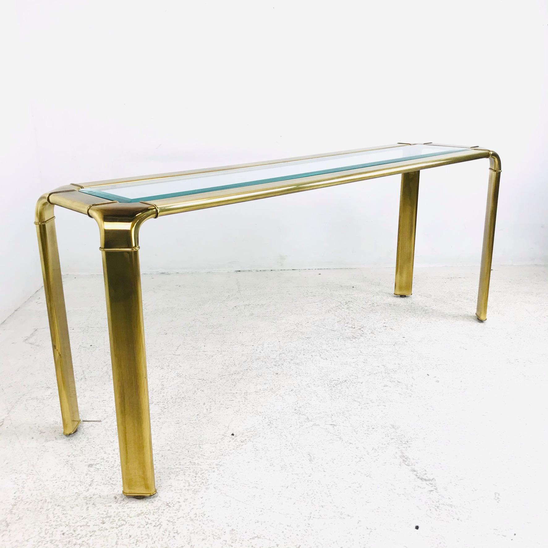 John Widdicomb Mastercraft style console table in brass with glass top.