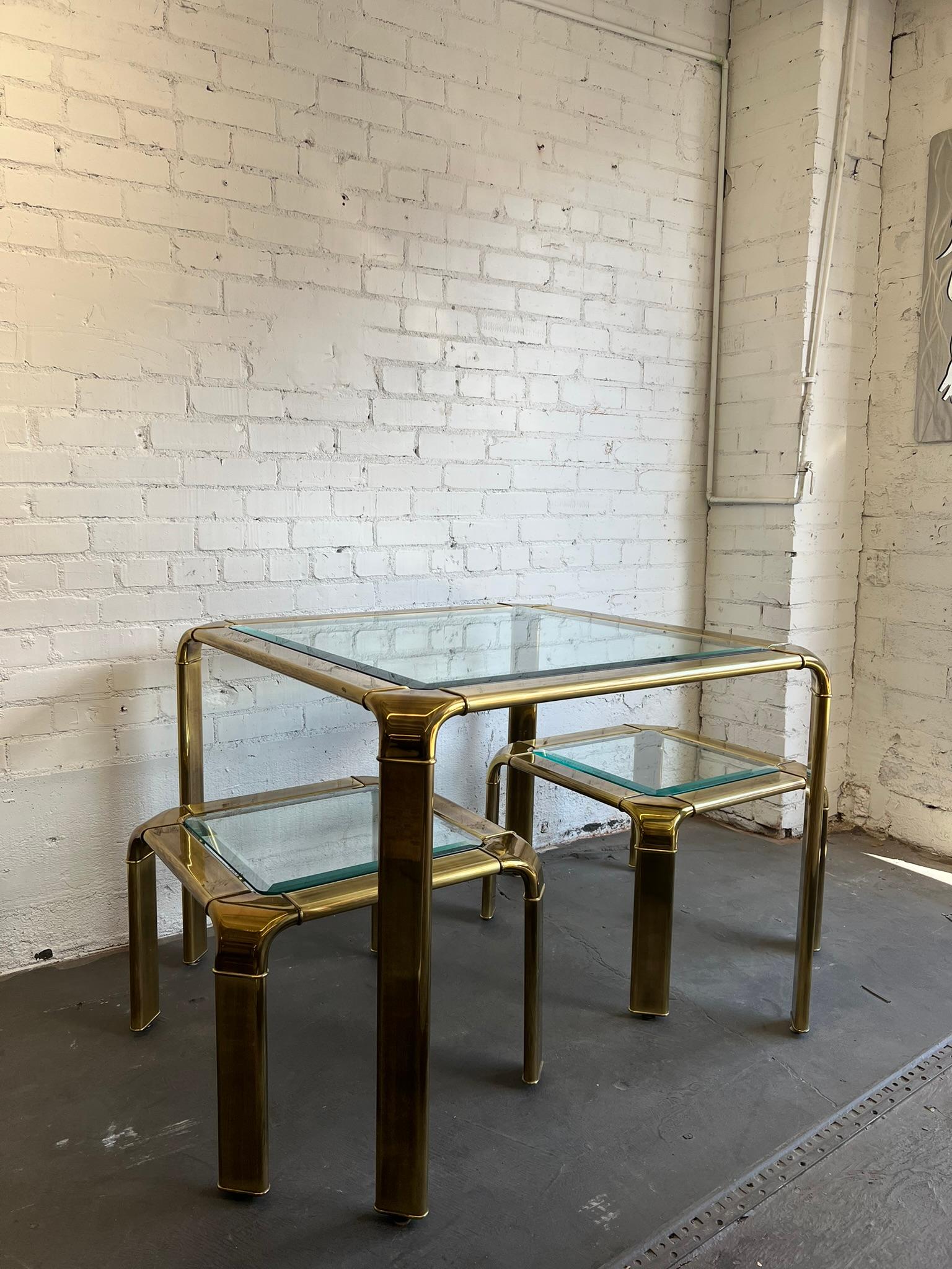 Beautifully designed 1980’s John Widdicomb brass waterfall side tables. Complete with an antiqued brass bodies and thick beveled glass tops.

Coffee tables, and consoles by Widdicomb in this style are available in the marketplace. However, a