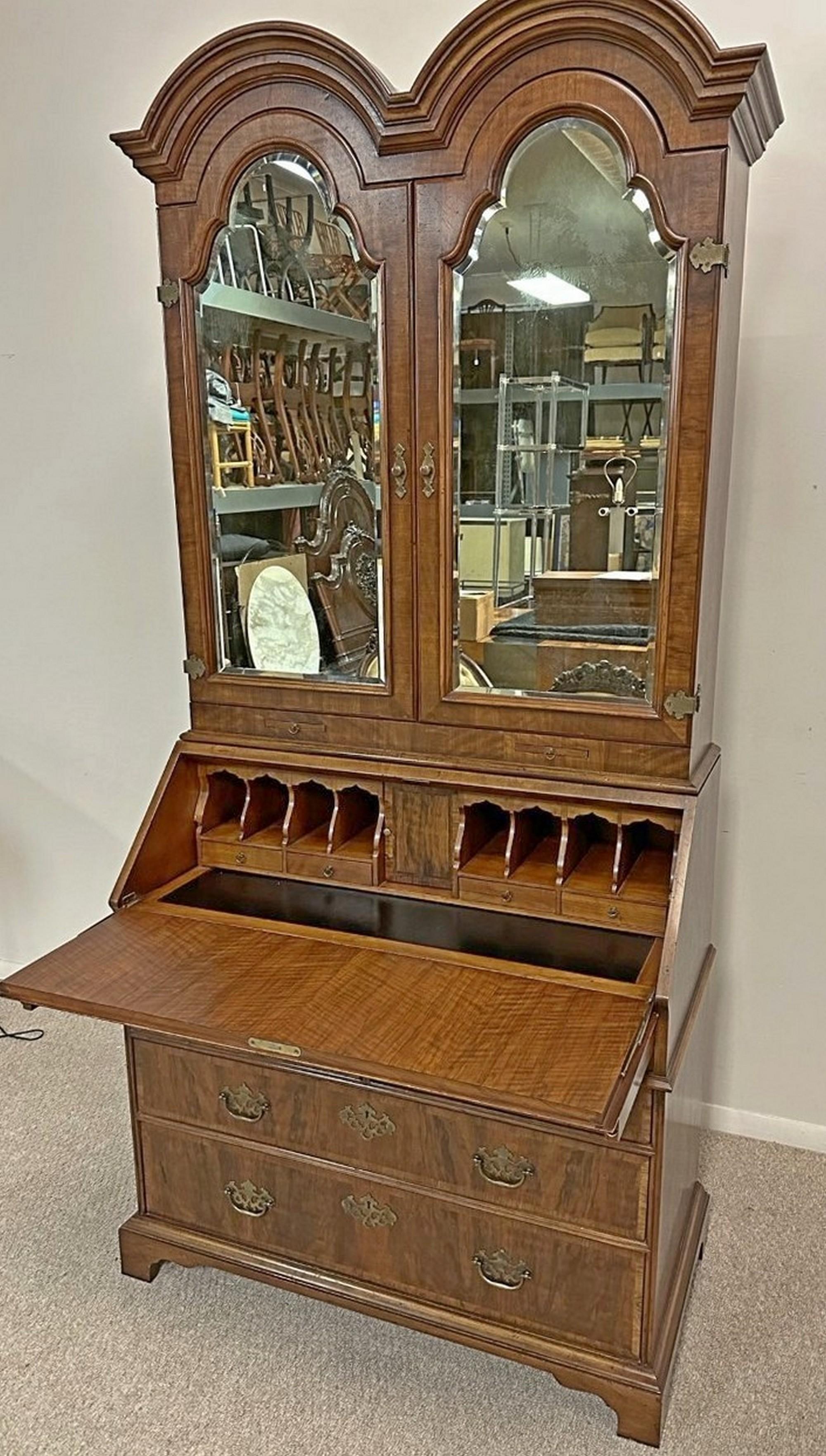 John Widdicomb Chippendale Style Secretary Desk. circa 20th century. A two-piece slant front walnut Chippendale desk model #2086. Banded wood inlay on two full sized drawers and drop front with leather writing surface. Leather desktop slides away to