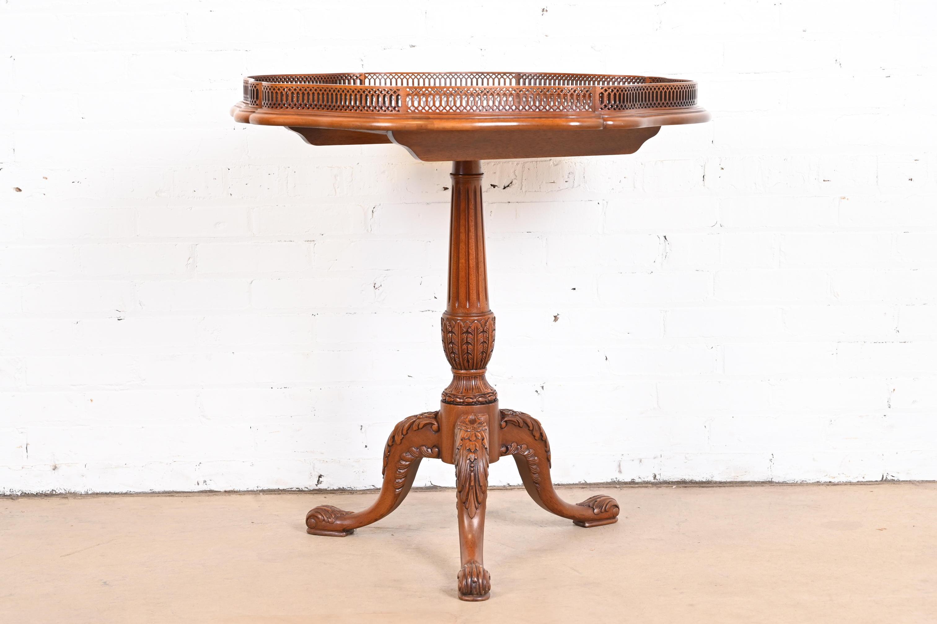 A gorgeous English Chippendale style carved mahogany pedestal tea table or occasional side table

By John Widdicomb

USA, Late 20th Century

Measures: 30.5