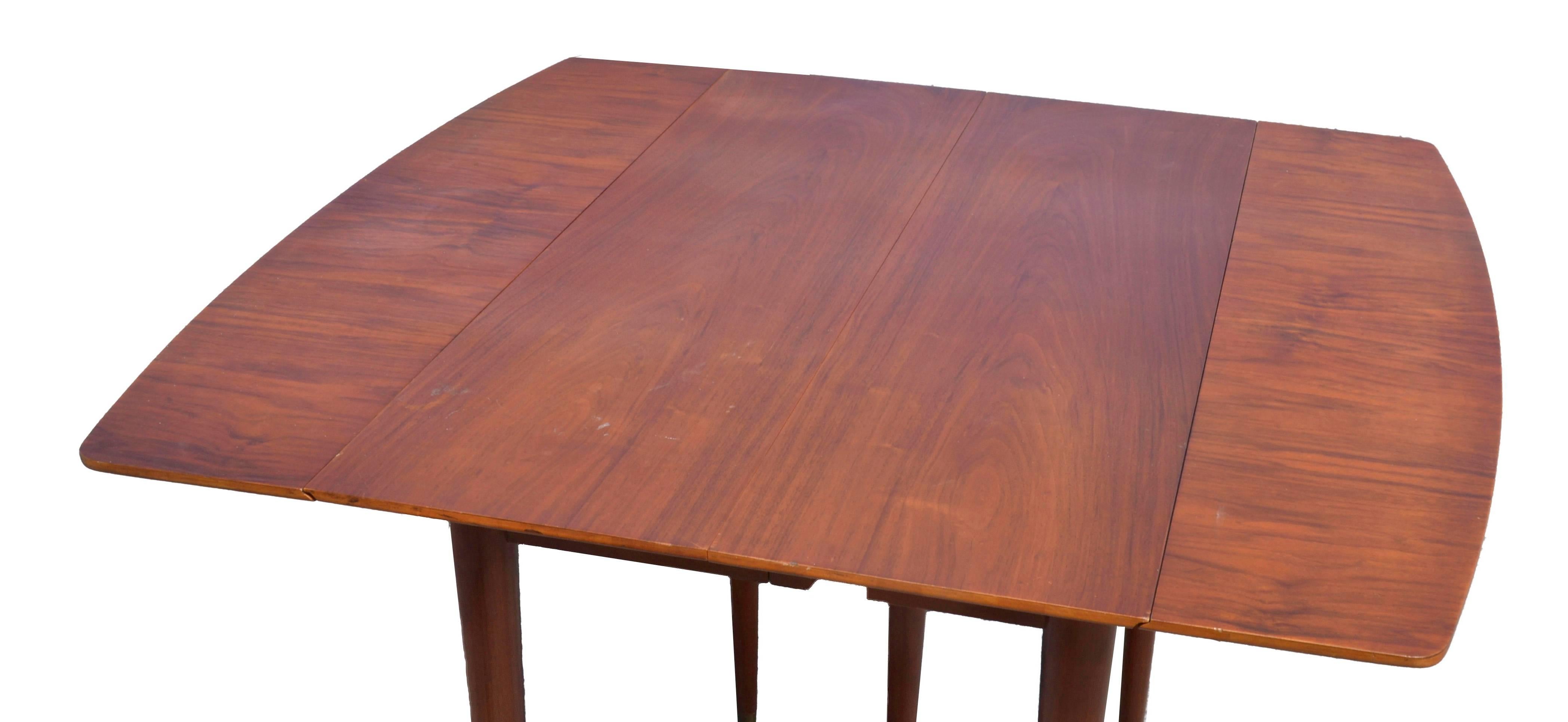 1950 Vintage John Widdicomb Mid-Century Modern walnut finish extension table with four leaves.
Four leaves each 13.5 inches wide. 
Max table length is 93.75 inches.
Seats eight People comfortable.
Smallest size is 39 inches long by 22.25 wide.