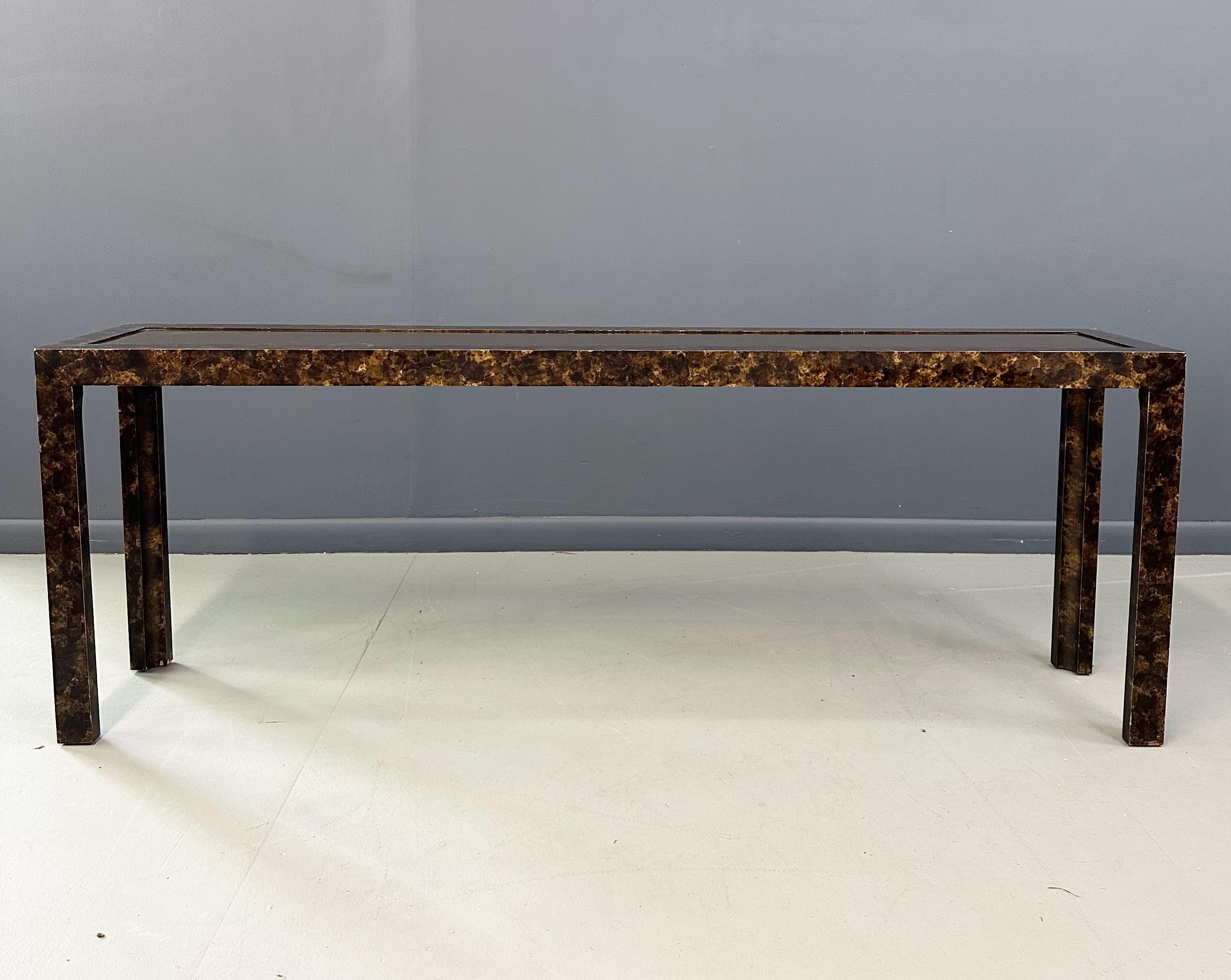 Indulge in luxury with the John Widdicomb Faux Tortoise Shell Console Table. The exquisite patinated brass top complements the realistic faux tortoise shell design, making it a statement piece in any room. Elevate your home decor with this elegant