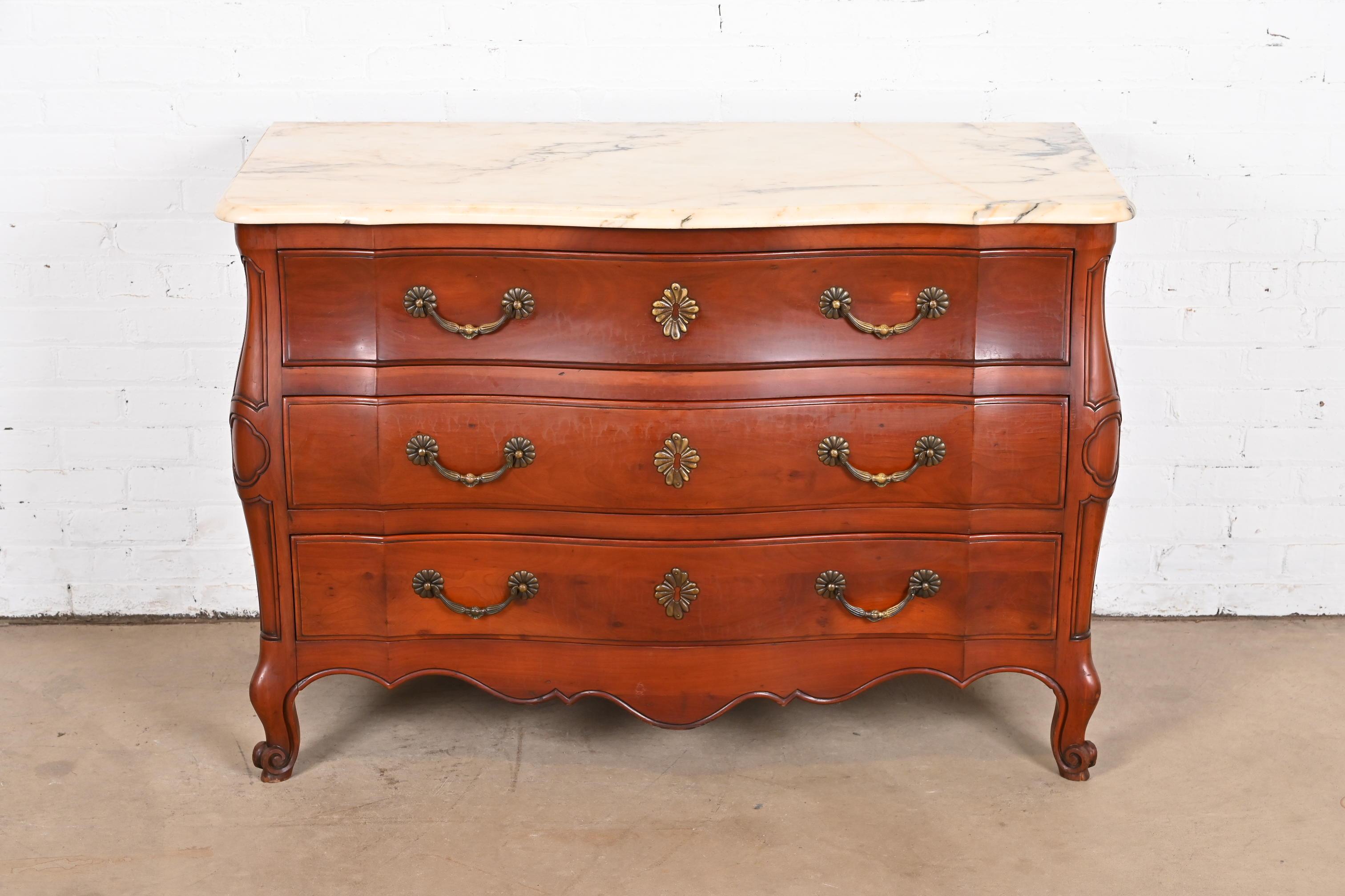 A gorgeous French Provincial Louis XV style bombay form commode or dresser chest

By Ralph Widdicomb for John Widdicomb Co.

USA, Circa 1940s

Solid carved cherry wood, with beveled marble top, and original brass hardware.

Measures: 49.25