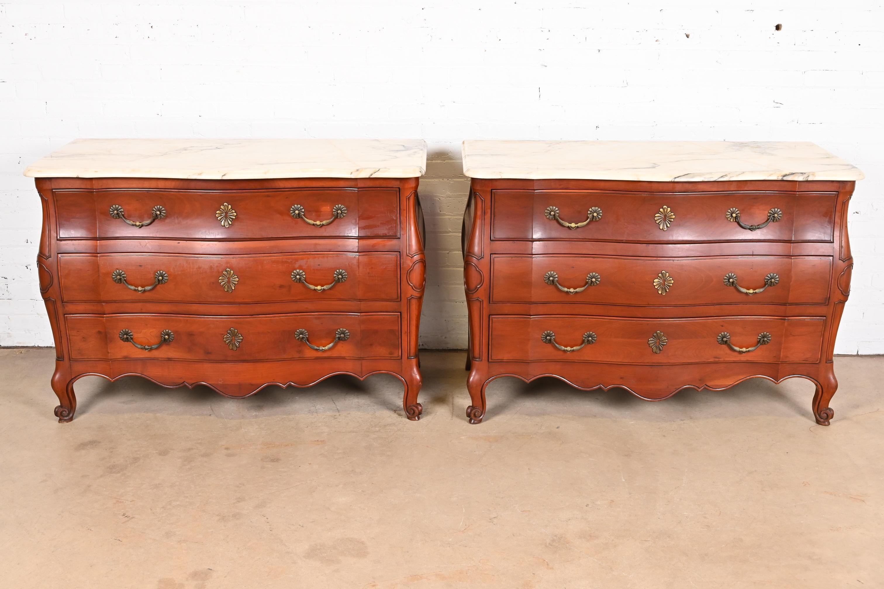 A gorgeous pair of French Provincial Louis XV style bombay form commodes or dresser chests

By Ralph Widdicomb for John Widdicomb Co.

USA, Circa 1940s

Solid carved cherry wood, with beveled marble tops, and original brass hardware.

Each measures: