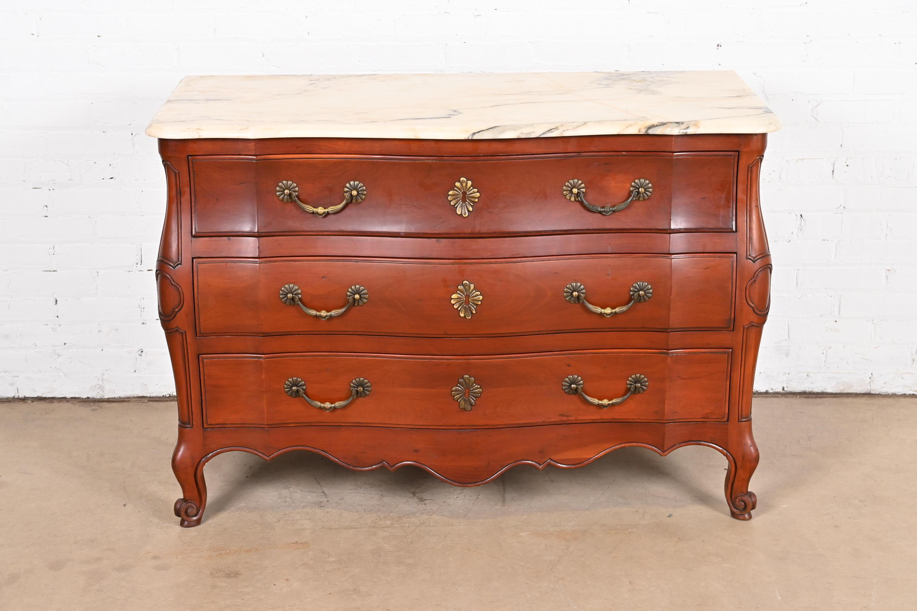 A gorgeous French Provincial Louis XV style bombay form commode or dresser chest

By Ralph Widdicomb for John Widdicomb Co.

USA, Circa 1940s

Solid carved cherry wood, with beveled marble top, and original brass hardware.

Measures: 49.25