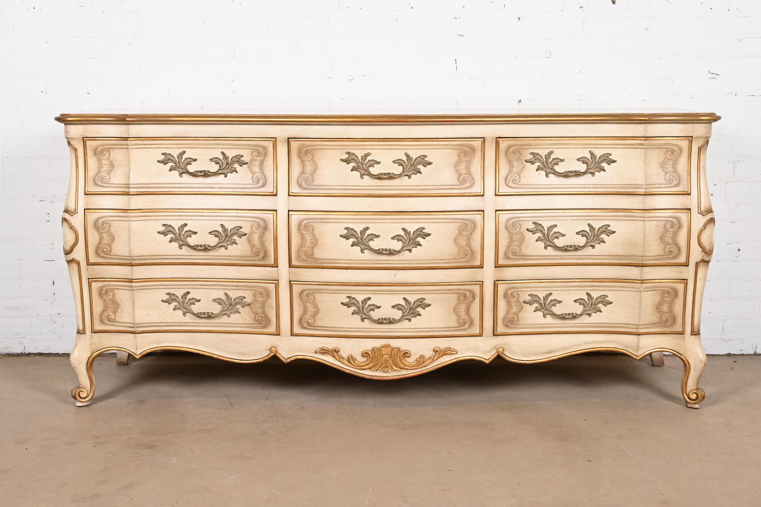 A gorgeous French Rococo or French Provincial Louis XV style nine-drawer dresser or credenza

By John Widdicomb

USA, Circa 1950s

Solid carved cherry wood, with original cream lacquered and gold gilt over red lacquer finish, and brass