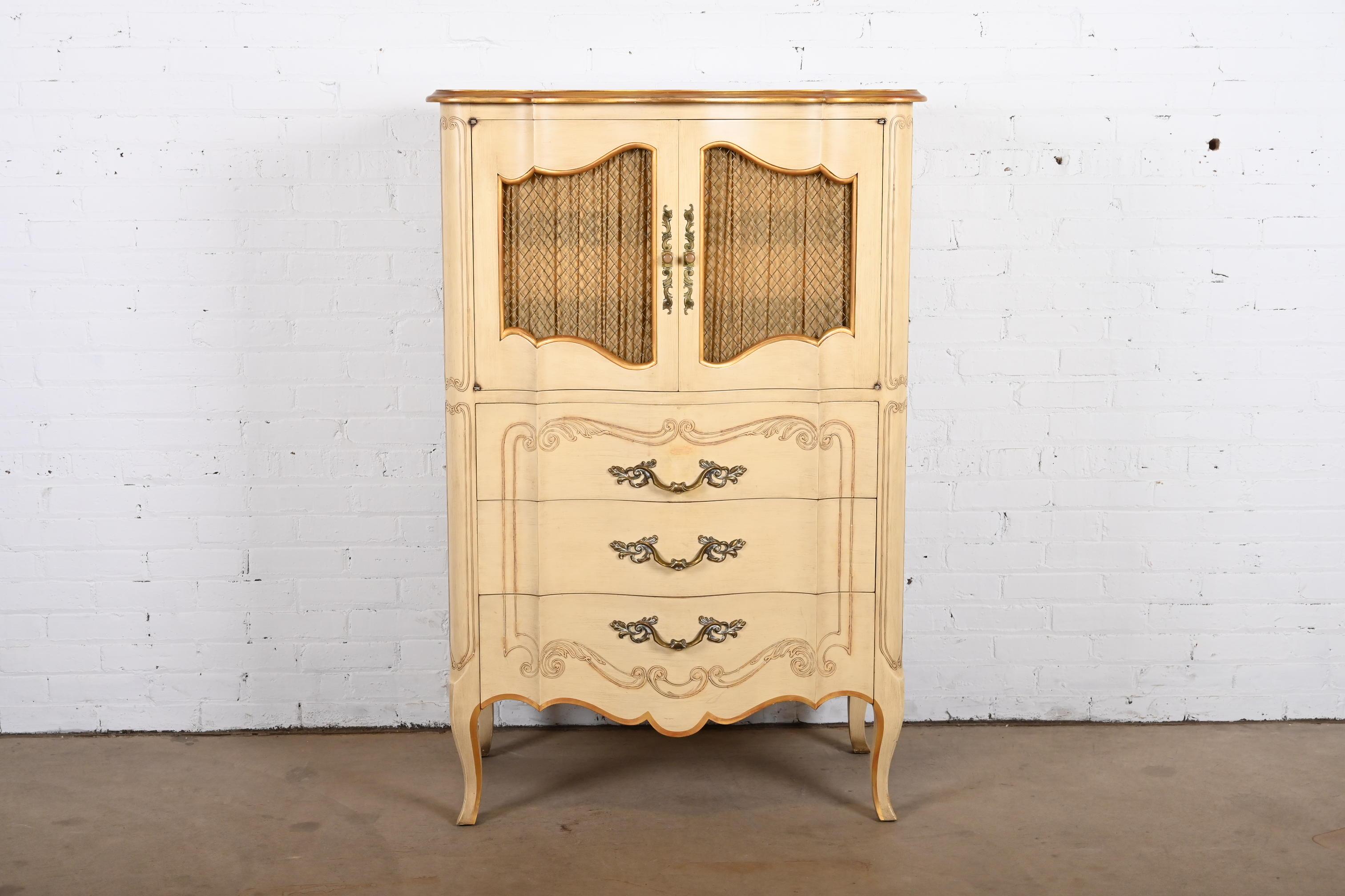 A gorgeous French Provincial Louis XV style carved highboy dresser or gentleman's chest

By John Widdicomb

USA, Circa 1950s

Solid carved cherry wood, with original painted and gold gilt finish and brass hardware.

Measures: 35.13