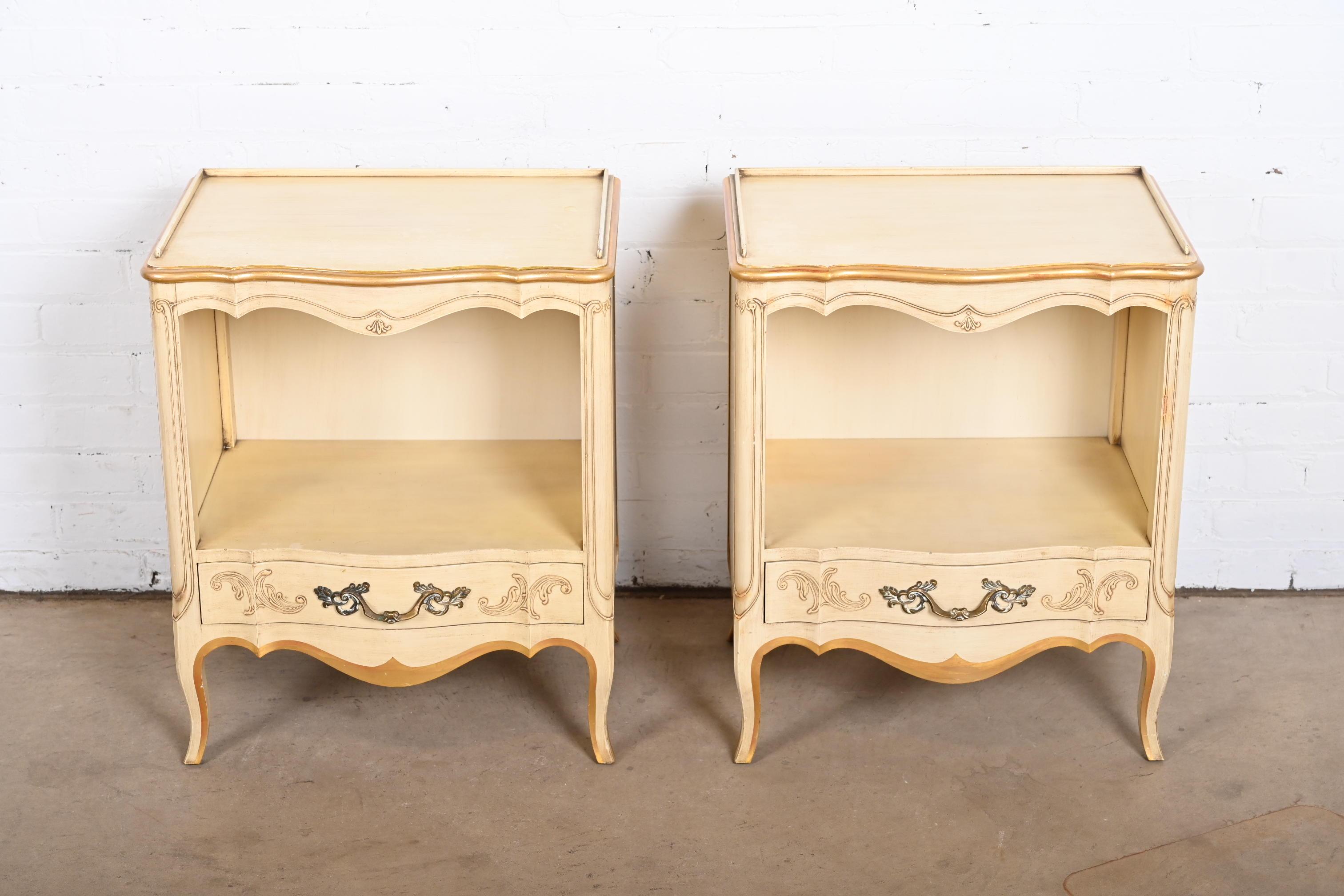 A gorgeous pair of French Provincial Louis XV style carved nightstands

By John Widdicomb

USA, Circa 1950s

Solid carved cherry wood, with original painted and gold gilt finish and brass hardware.

Measures: 19.5