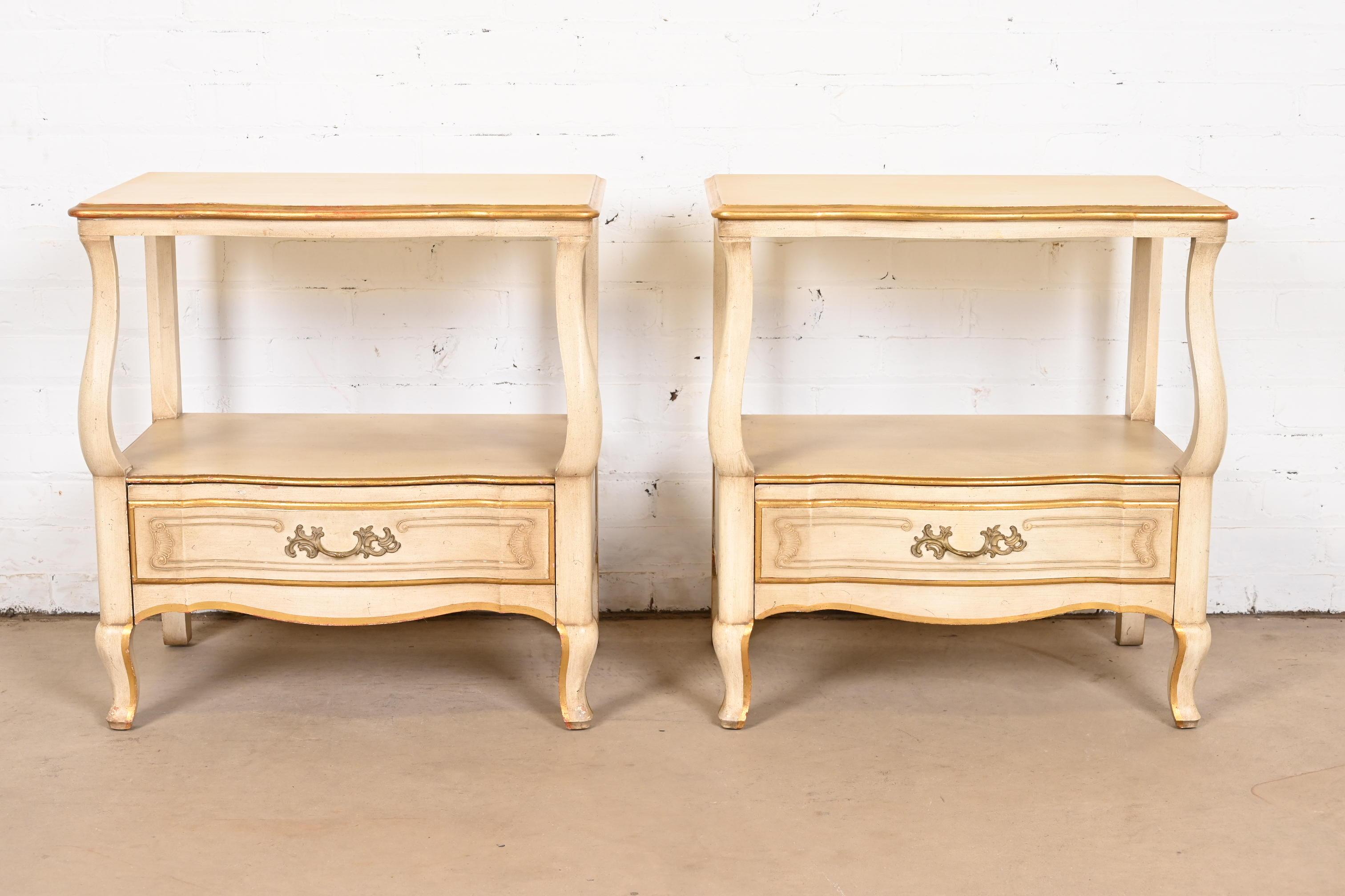 A gorgeous pair of French Rococo or French Provincial Louis XV style nightstands

By John Widdicomb

USA, Circa 1950s

Solid carved cherry wood, with original cream lacquered and gold gilt over red lacquer finish, and brass hardware.

Measures: 24