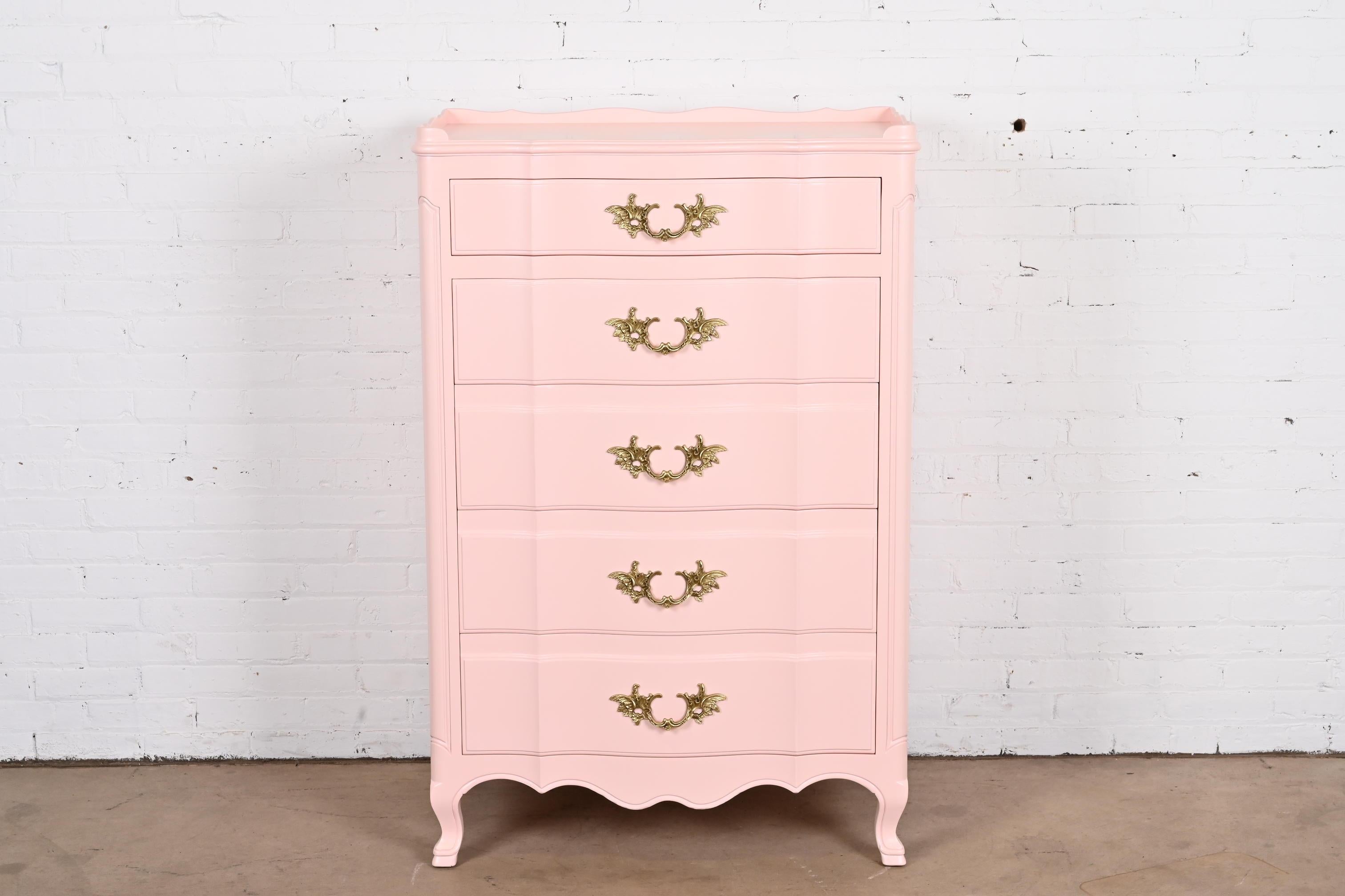 A gorgeous French Provincial Louis XV style five-drawer highboy dresser

By John Widdicomb

USA, Circa 1940s

Light pink lacquered solid cherry wood, with original brass hardware.

Measures: 33.25