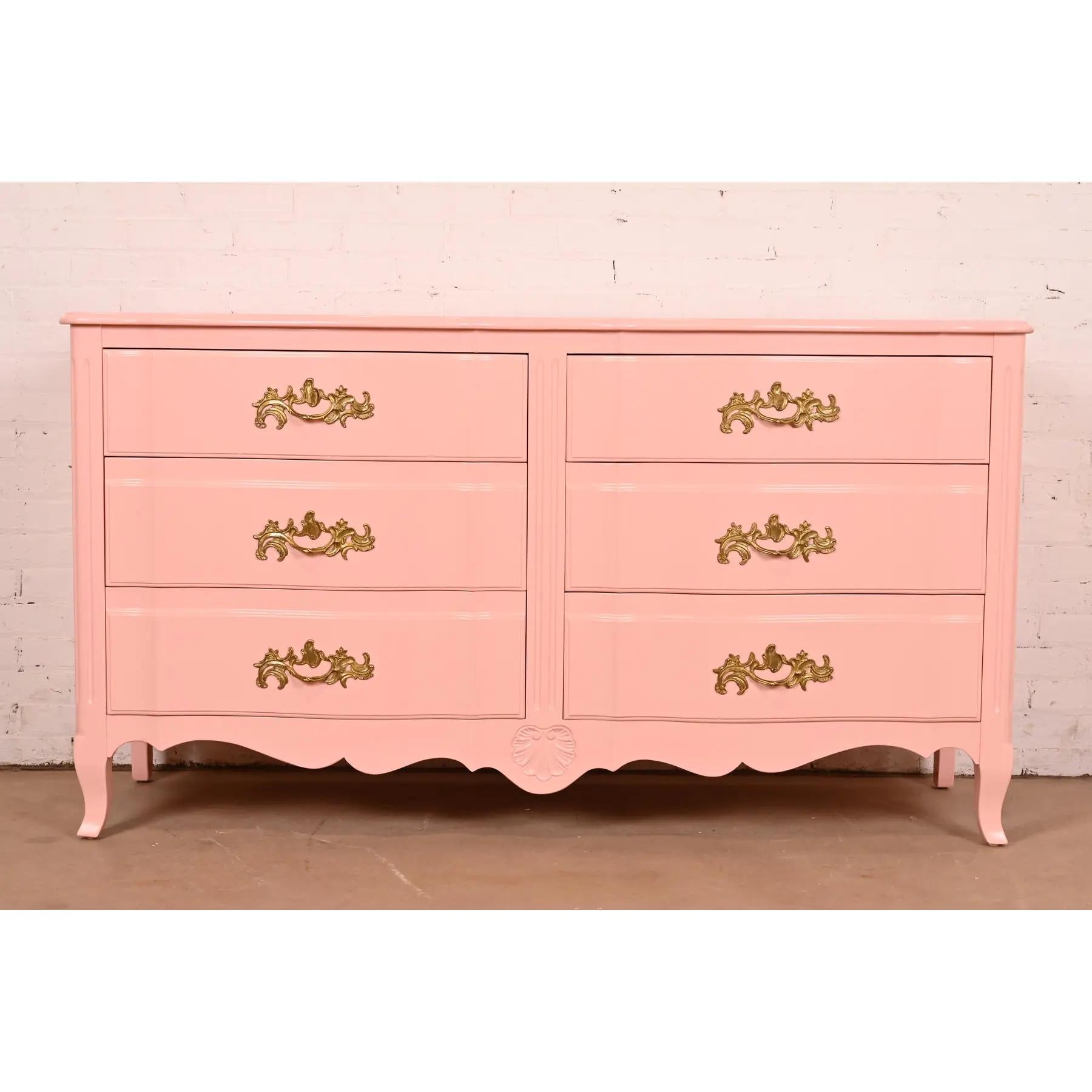 An exceptional French Provincial Louis XV style six-drawer dresser or credenza

Designed by Ralph Widdicomb for John Widdicomb Co.

USA, Circa 1940s

Pink lacquered carved solid cherry wood, with original brass hardware.

Measures: 64