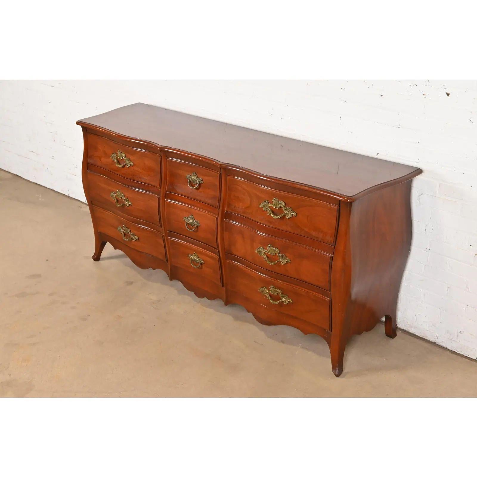 An exceptional French Provincial Louis XV style bombay form nine-drawer dresser or chest of drawers

Designed by Ralph Widdicomb for John Widdicomb

USA, Circa 1940s

Carved solid mahogany, with original brass hardware.

Measures: 75