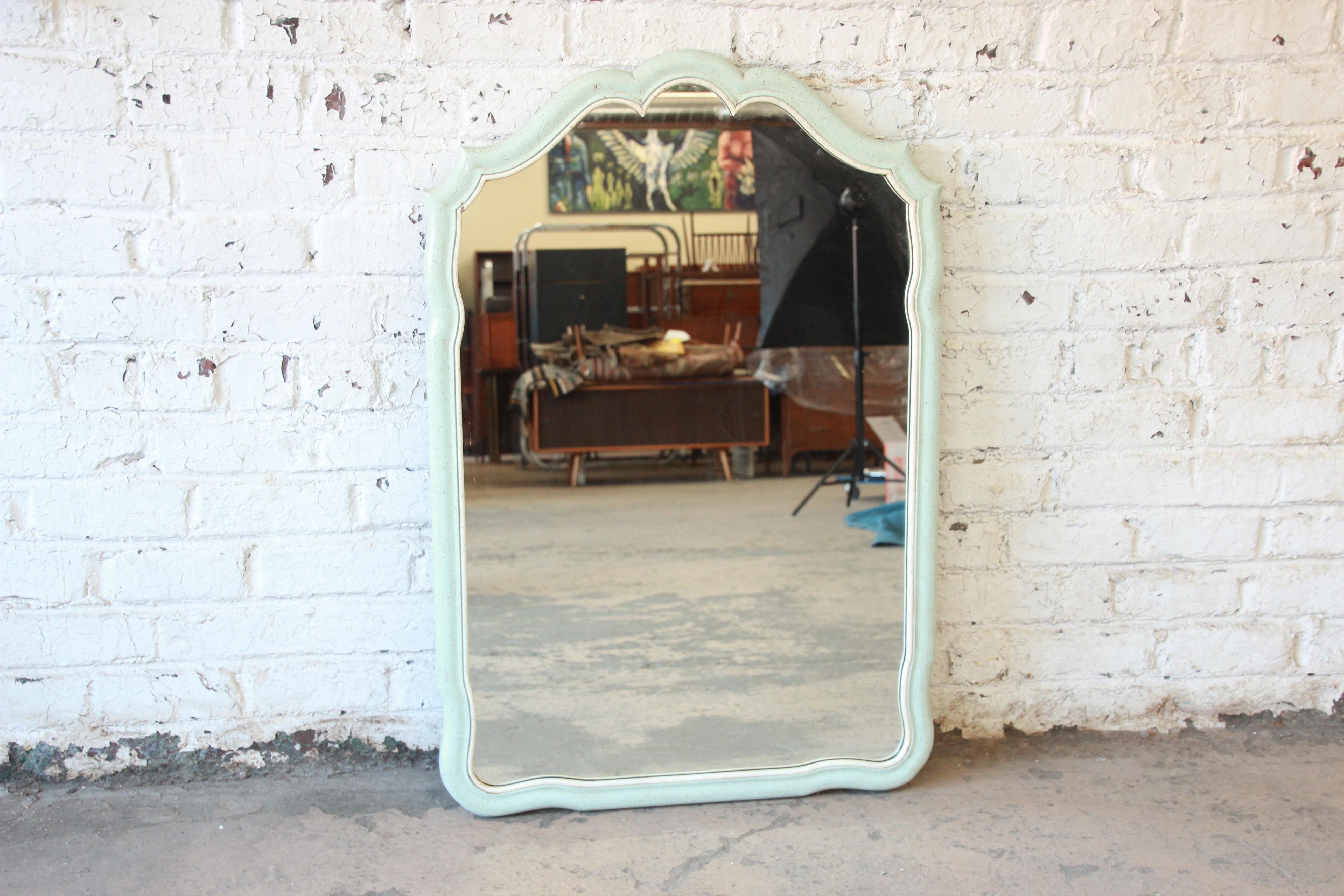 A gorgeous vintage French Provincial Louis XV style mirror by John Widdicomb. The mirror has a nice wood frame with original baby blue painted finish with cream trim. The original John Widdicomb label is present on the back side of the mirror. The