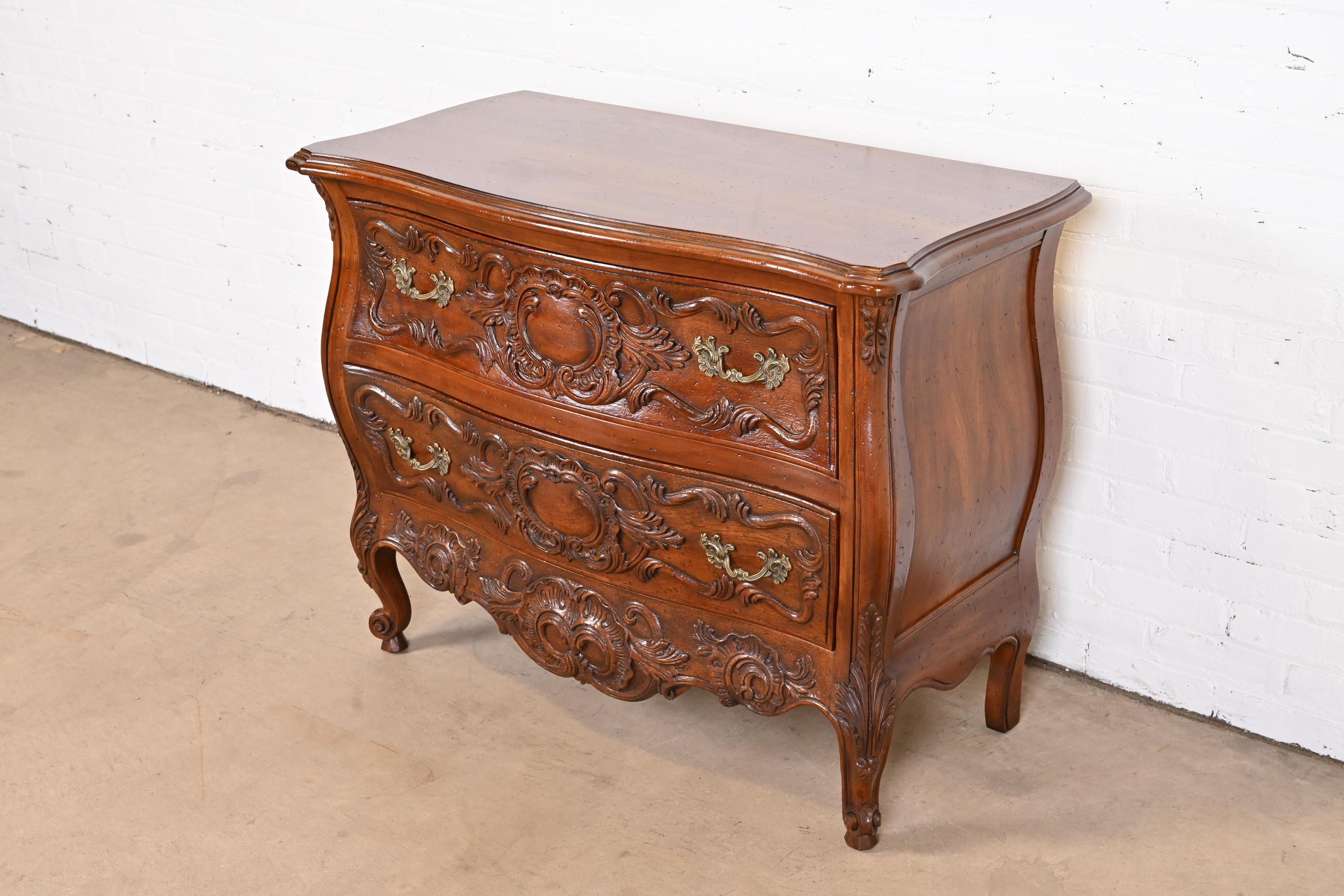 A gorgeous French Provincial Louis XV style bombay form commode or dresser chest

By John Widdicomb and retailed by John Stuart

USA, Circa 1960s

Solid carved walnut, with original brass hardware.

Measures: 42
