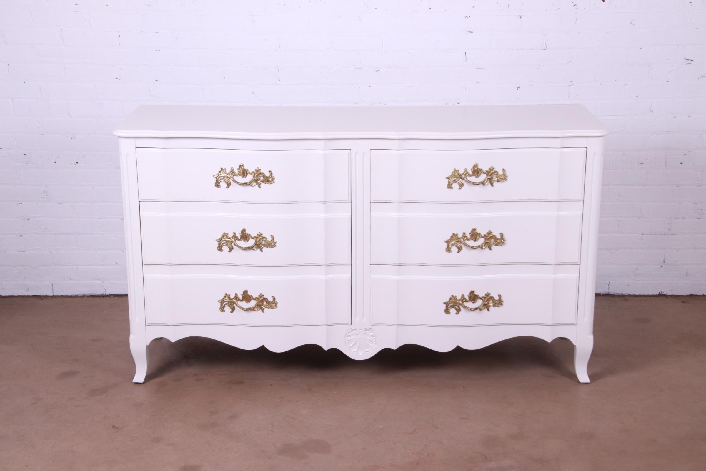 An exceptional French Provincial Louis XV style six-drawer dresser or credenza

Designed by Ralph Widdicomb for John Widdicomb Co.

USA, Circa 1940s

White lacquered carved solid cherry wood, with original brass hardware.

Measures: 64