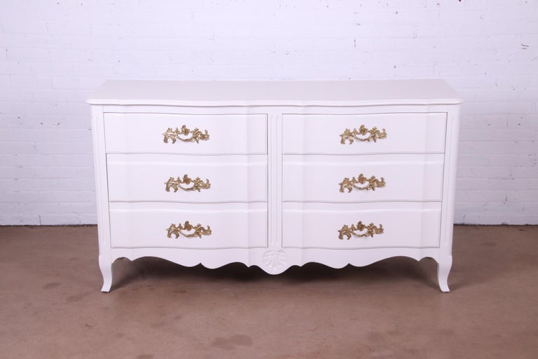 An exceptional French Provincial Louis XV style six-drawer dresser or credenza

Designed by Ralph Widdicomb for John Widdicomb Co.

USA, Circa 1940s

White lacquered carved solid cherry wood, with original brass hardware.

Measures: 64