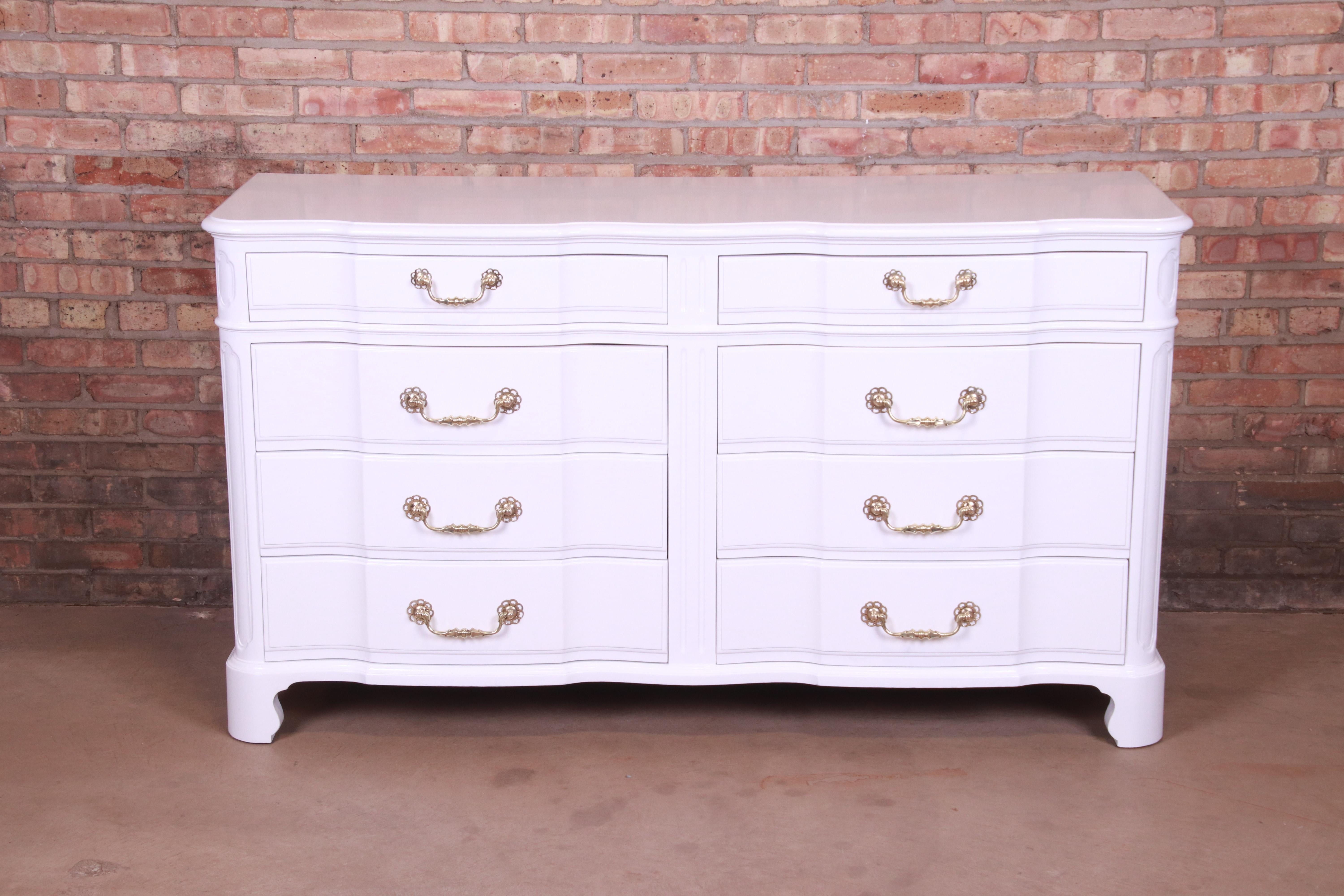 An exceptional French Provincial eight-drawer dresser or credenza

Designed by Ralph Widdicomb for John Widdicomb Co.

USA, Circa 1940s

White lacquered carved mahogany, with original brass hardware.

Measures: 63.13