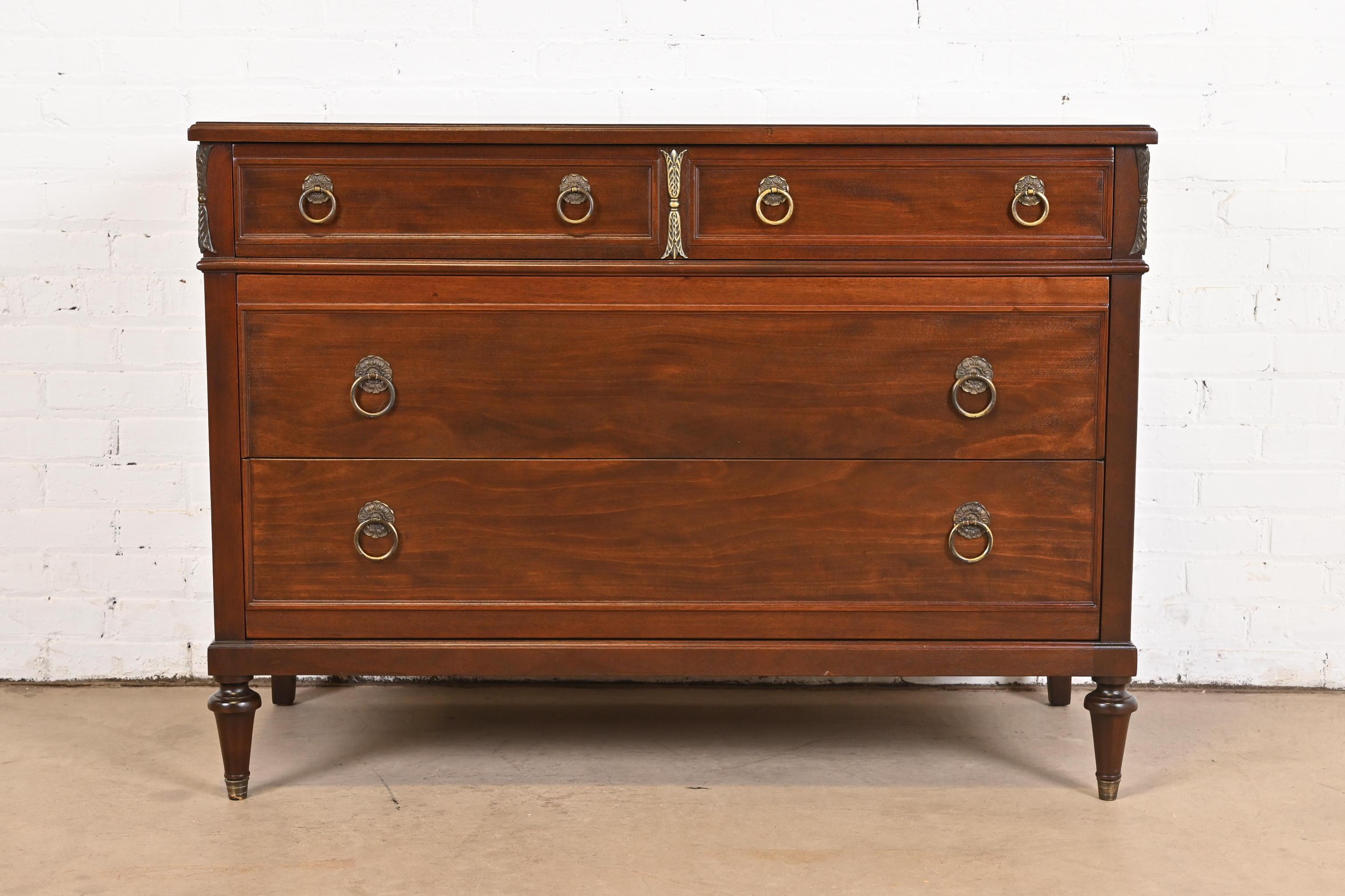 A beautiful French Regency Louis XVI style dresser or chest of drawers

By Ralph Widdicomb for John Widdicomb Co.

USA, Circa 1940s

Carved mahogany, with mounted brass ormolu, brass hardware, and brass-capped feet.

Measures: 46