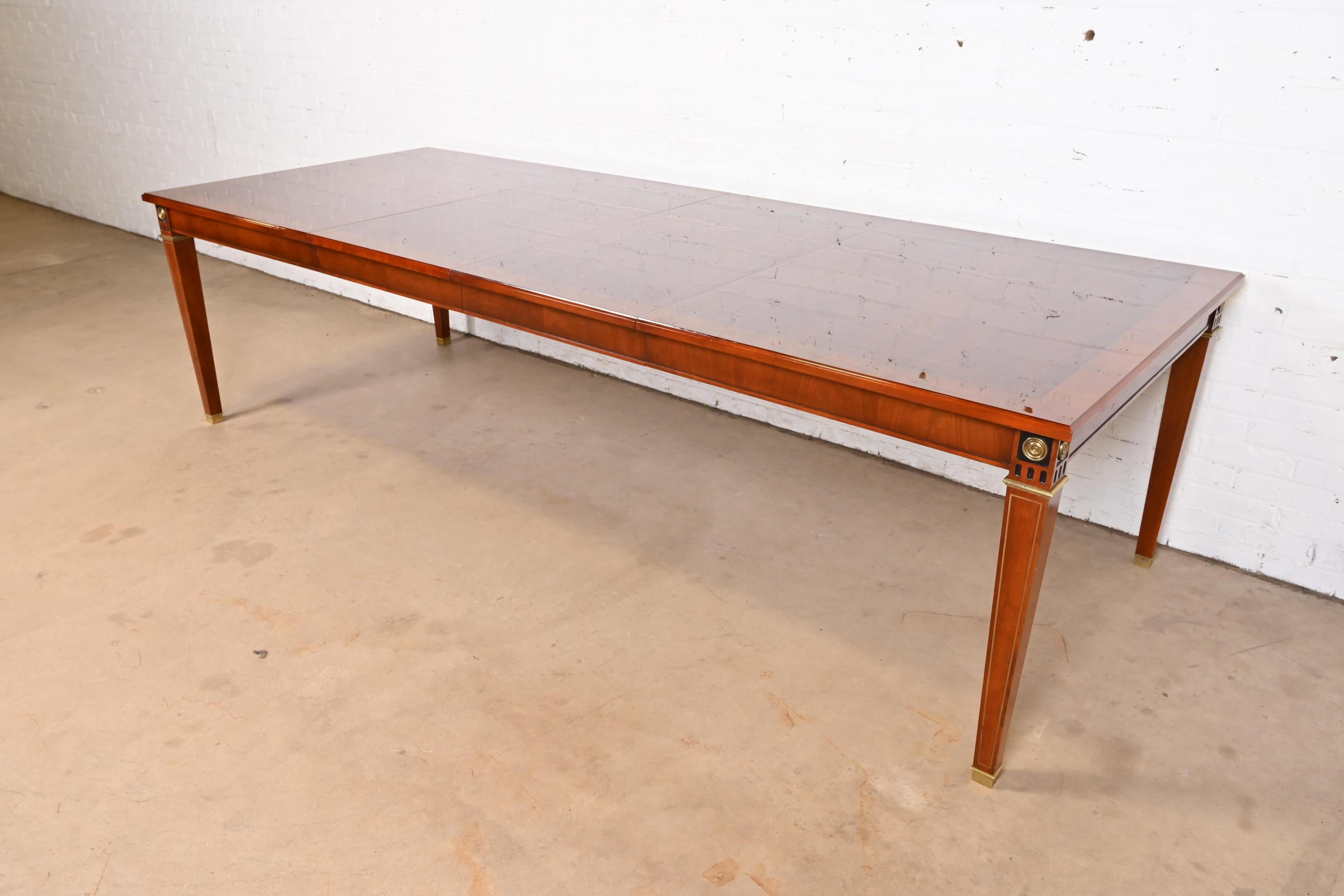 Exceptionnelle table de salle à manger à rallonge de style Louis XVI ou néoclassique de la Régence française

Par John Widdicomb

États-Unis, fin du 20e siècle

Magnifique acajou assorti aux livres, avec bois ébonisé et détails dorés, sabots et