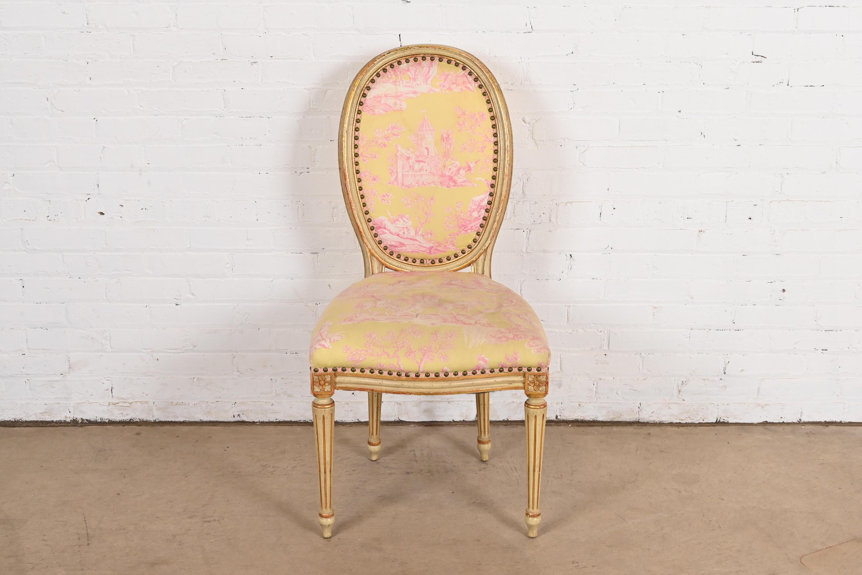 A beautiful French Regency Louis XVI style side chair or desk chair

By John Widdicomb

USA, Circa 1960s

Solid cherry wood, with original cream painted and parcel gilt finish, and brass studded upholstered seat and back.

Measures: 20