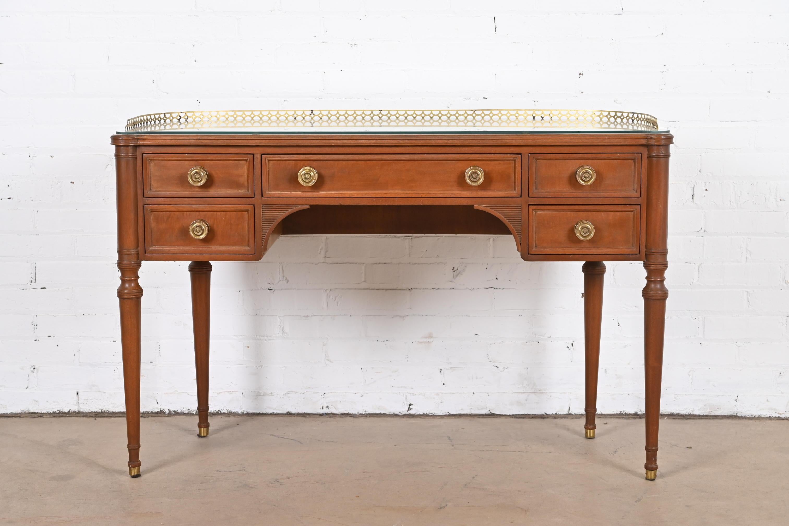 A gorgeous French Regency Louis XVI style demilune writing desk

By Ralph Widdicomb for John Widdicomb Co.

USA, Circa 1950s

Carved walnut, with brass gallery and hardware.

Measures: 47.75