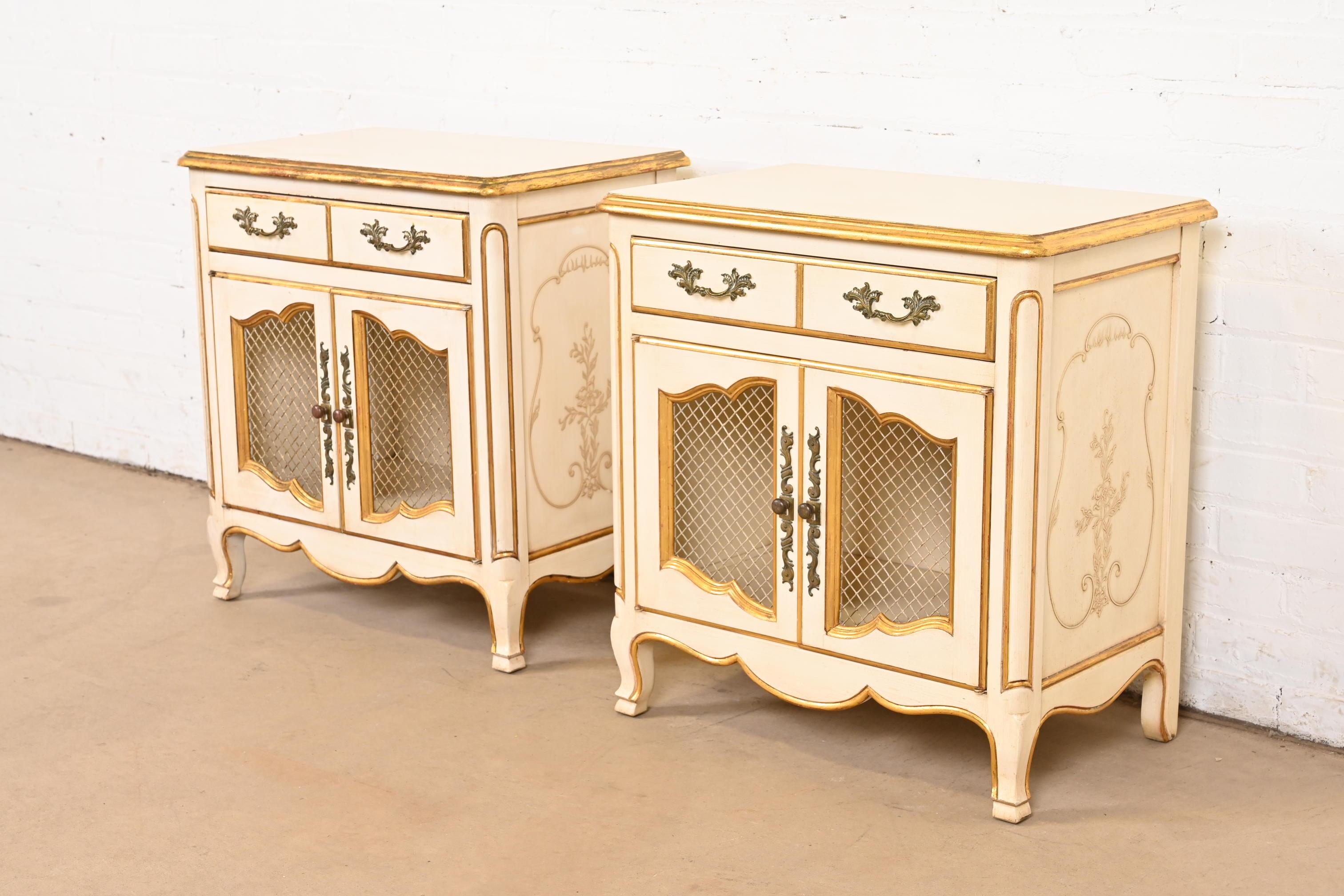 A gorgeous pair of French Rococo or French Provincial Louis XV style nightstands

By John Widdicomb

USA, Circa 1950s

Solid carved cherry wood, with original cream lacquered and gold gilt finish, and brass hardware.

Each measures: 24