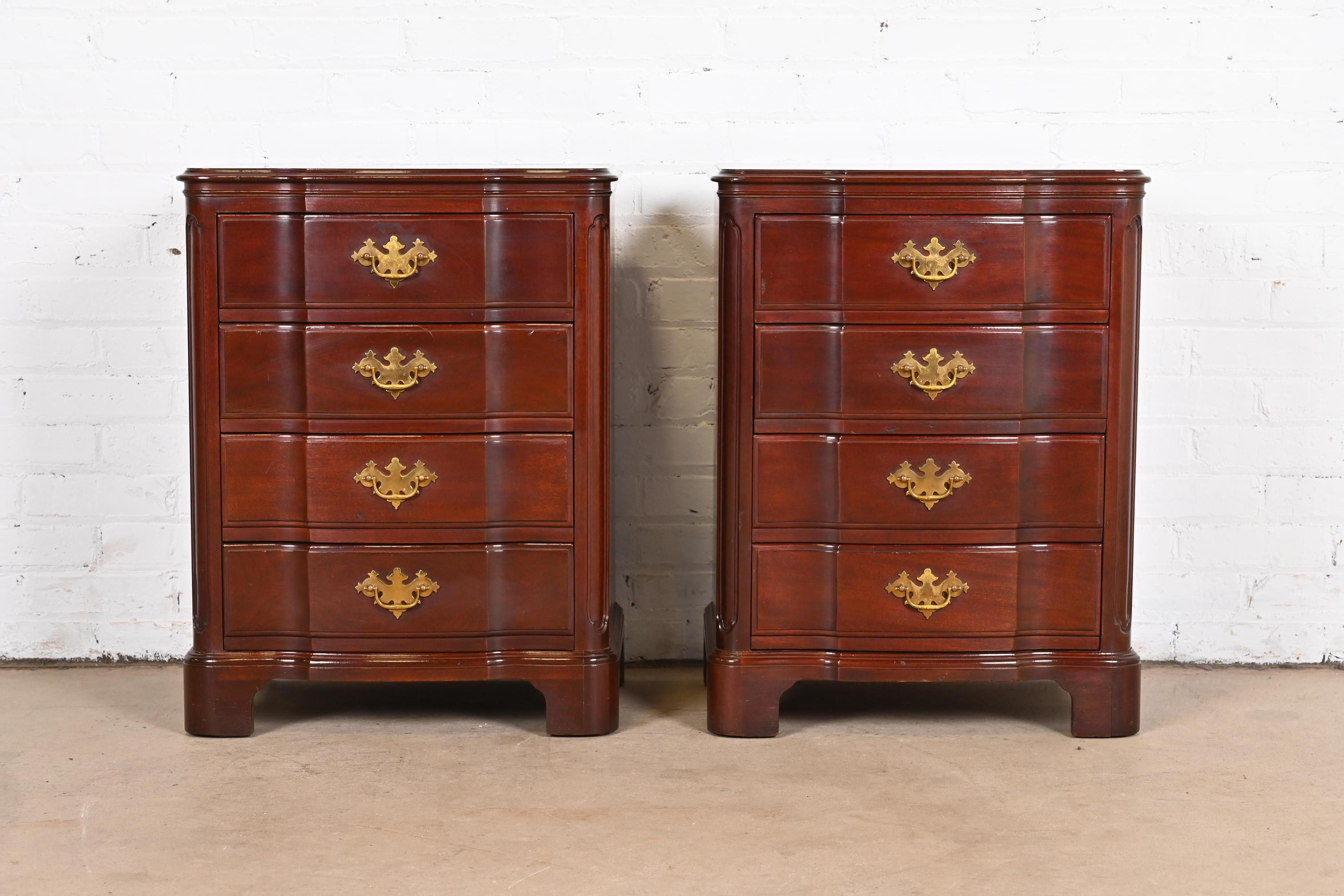 A gorgeous pair of Georgian or Chippendale style four-drawer nightstands or chests of drawers

By John Widdicomb

USA, Circa 1950s

Solid carved mahogany, with original brass hardware.

Measures: 21