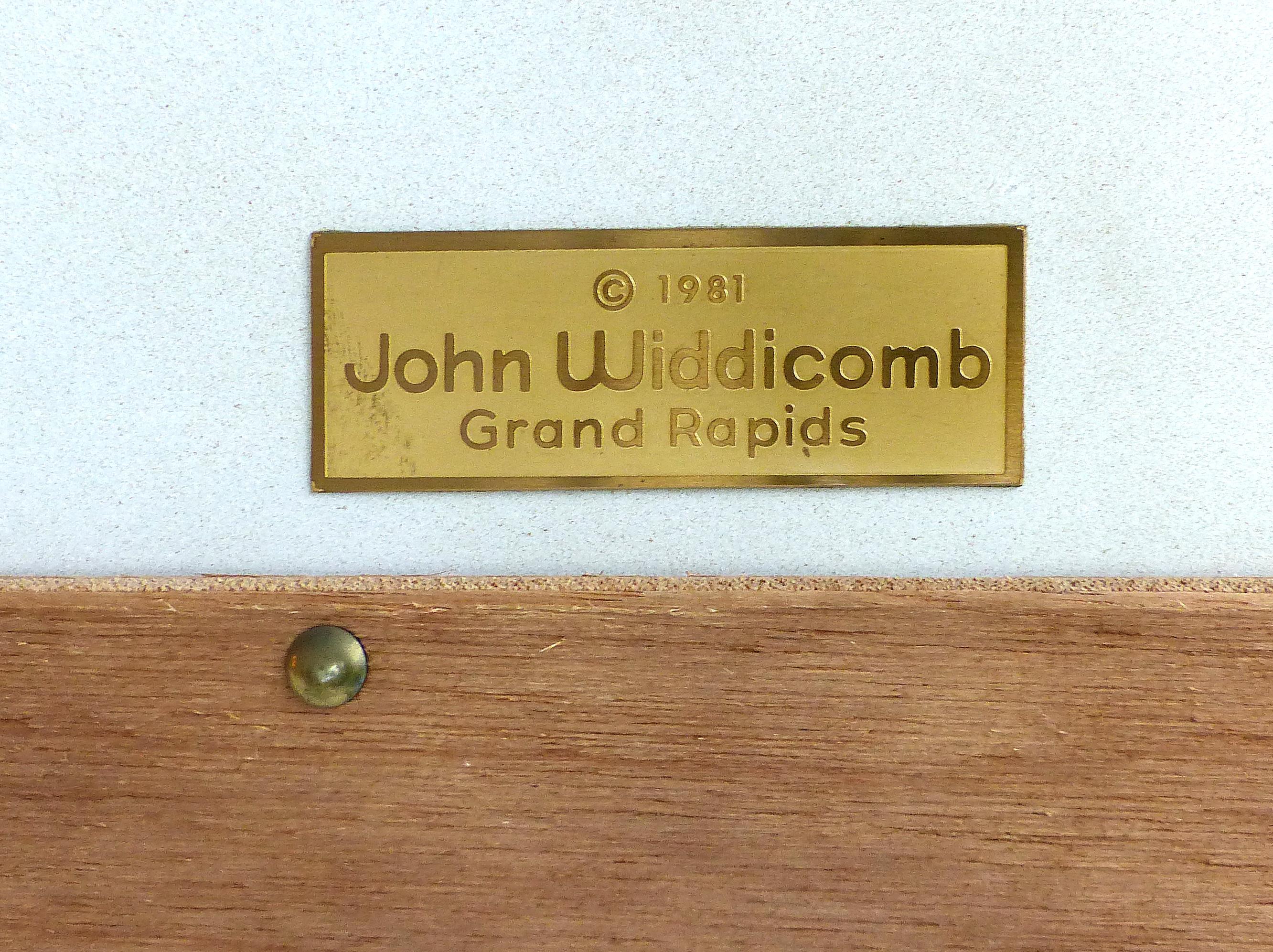 John Widdicomb Hand Painted Wood Mirror

Offered for sale is a hand painted wood mirror manufactured by the John Widdicomb. The frame has raised scrolled details and a subtle molded pediment and base. The mirror retains the Widdicomb metal tag on