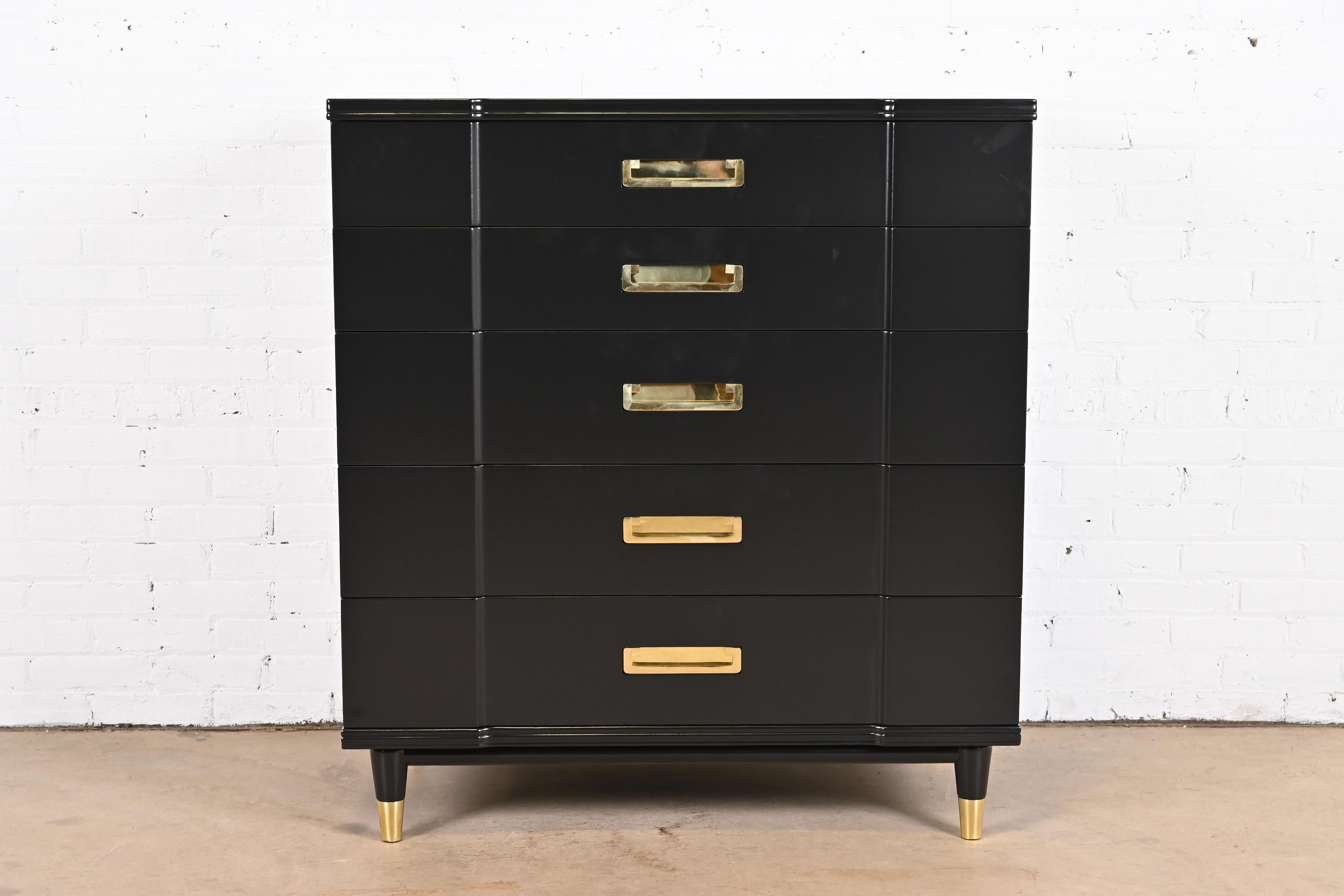 An exceptional mid-century modern Hollywood Regency Campaign five-drawer highboy dresser

By John Widdicomb

USA, 1950s

Black lacquered solid cherry wood, with original brass hardware and brass-capped feet.

Measures: 40.38