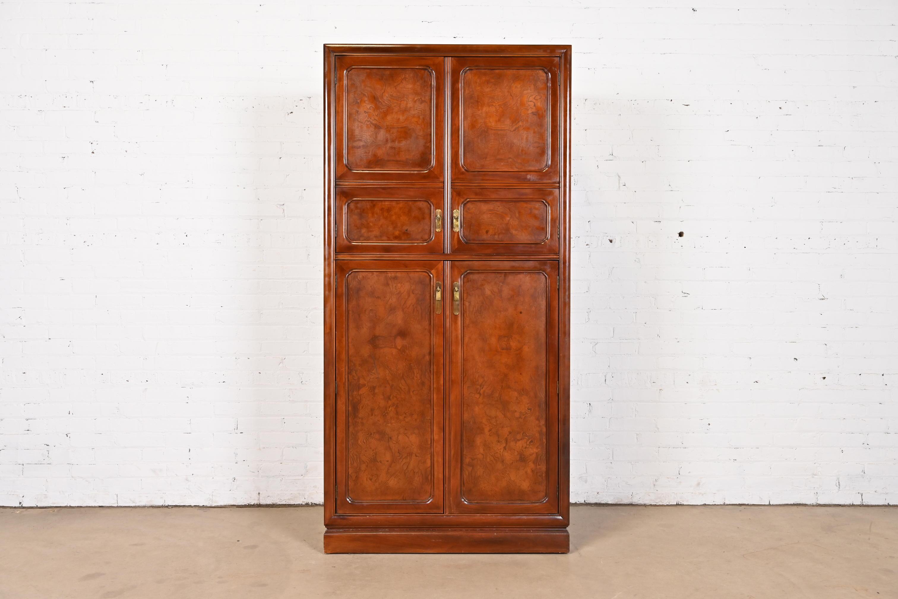 An exceptional mid-century modern Hollywood Regency Chinoiserie gentleman's chest or armoire dresser

By John Widdicomb

USA, Circa 1970s

Burled walnut, with original  brass hardware. Shelves are adjustable

Measures: 36