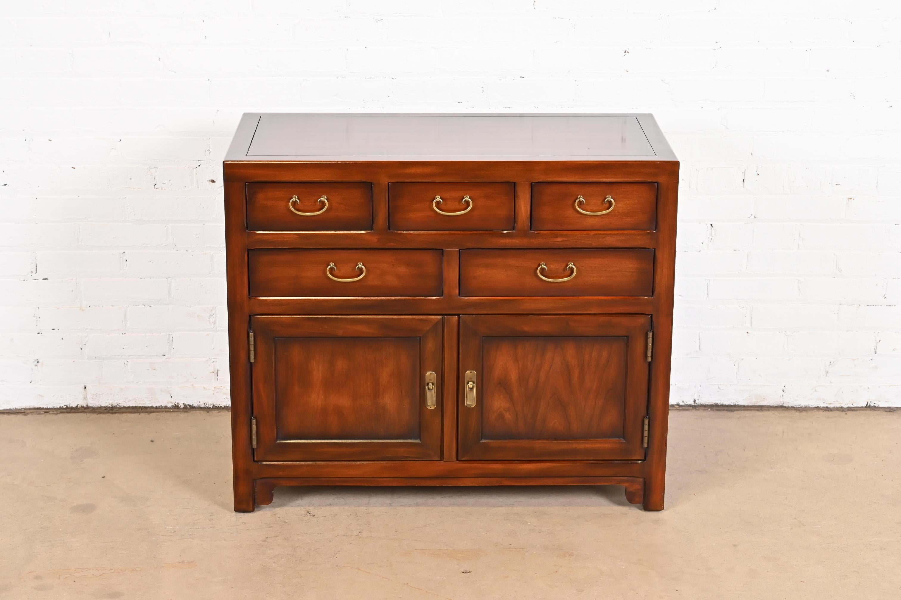 An exceptional Mid-Century Modern Hollywood Regency chinoiserie server or bar cabinet

By John Widdicomb

USA, circa 1970s

Gorgeous mahogany, with original Asian-inspired brass hardware.

Measures: 36