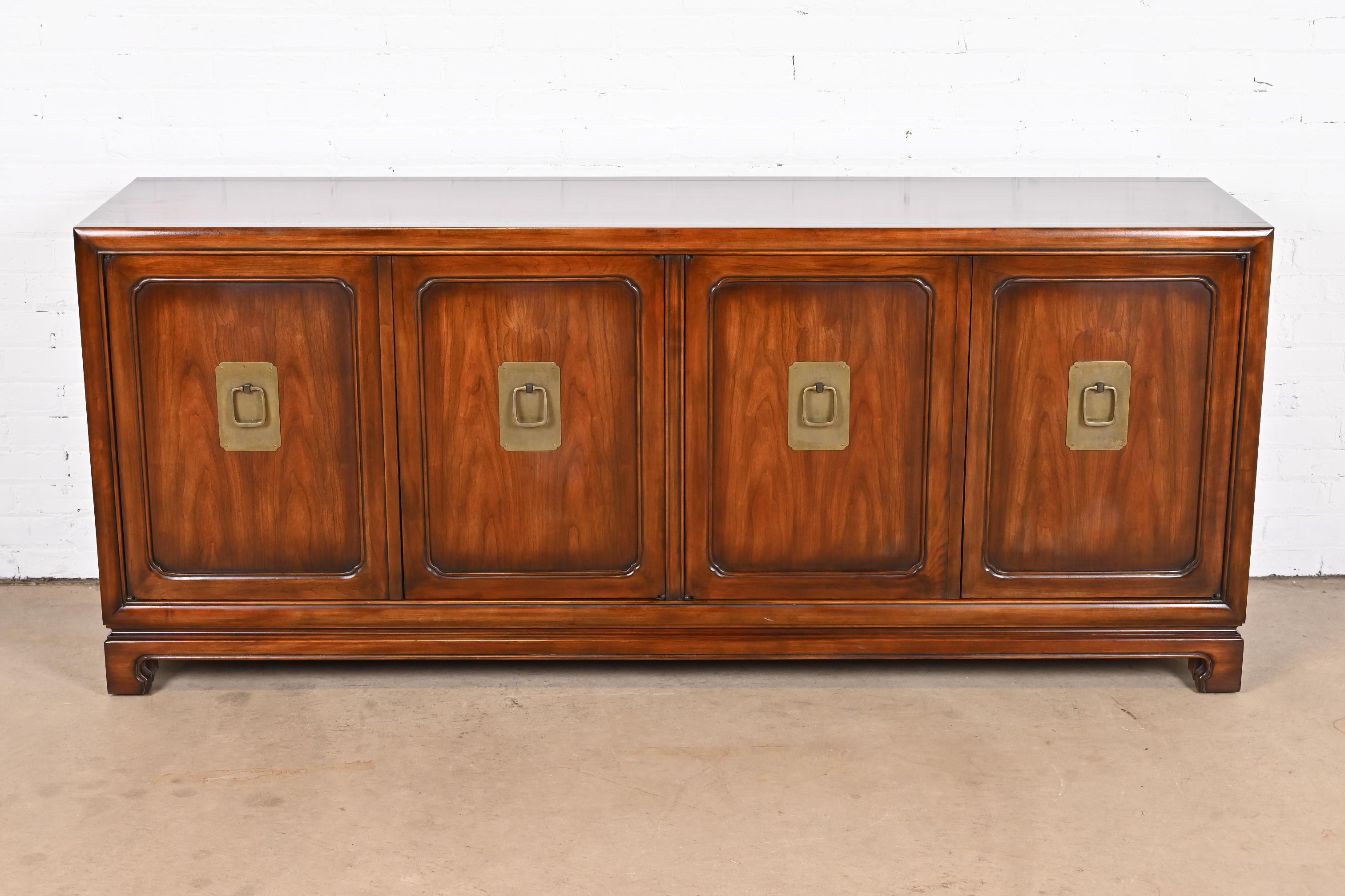 An exceptional Mid-Century Modern Hollywood Regency chinoiserie sideboard, credenza, or bar cabinet

By John Widdicomb

USA, circa 1960s

Gorgeous book-matched walnut, with original brass hardware.

Measures: 76.38