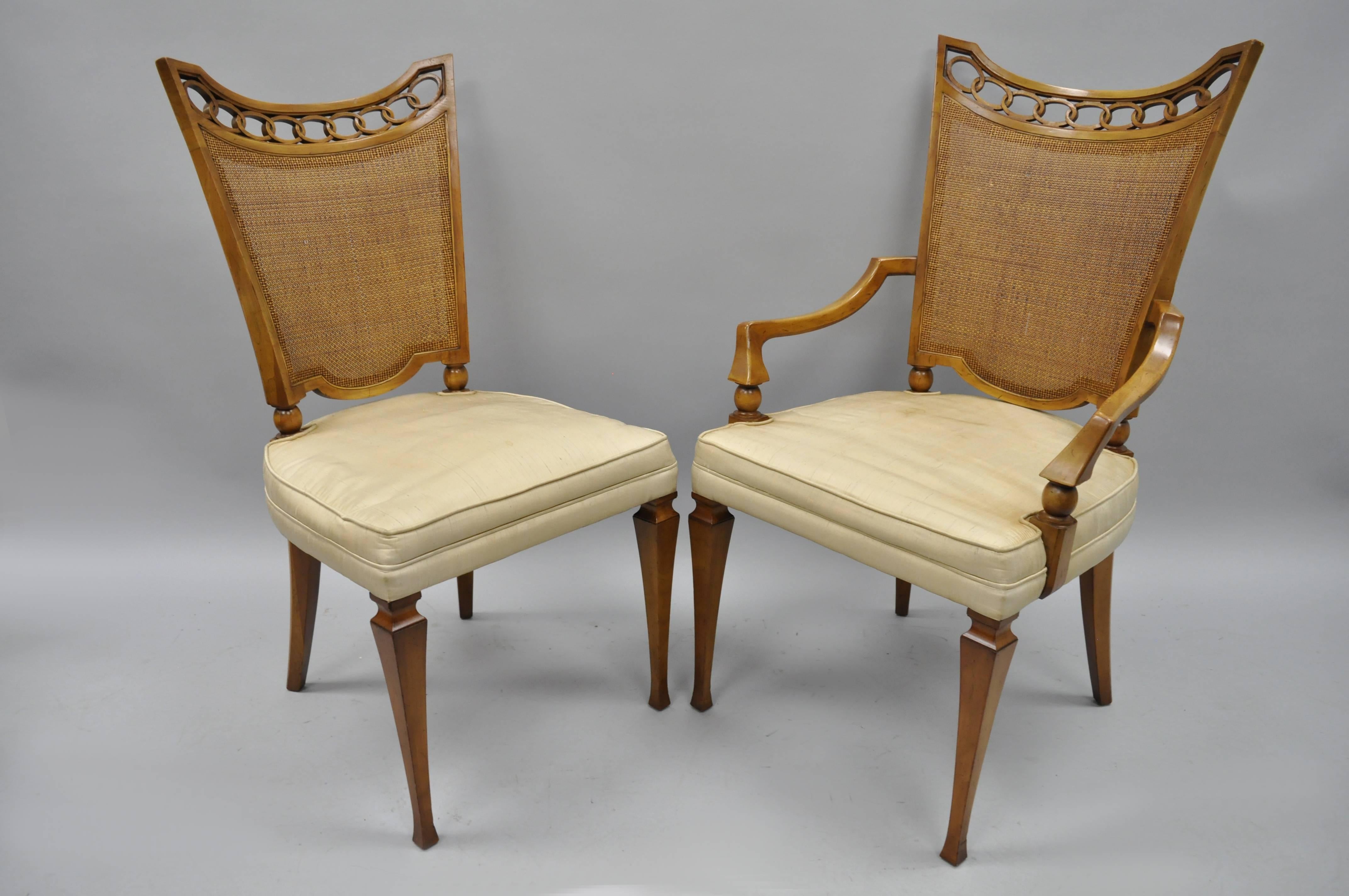 Set of six walnut John Widdicomb Hollywood Regency French style cane back dining chairs. Set features open carved top rails, quality American craftsmanship, cane backs, and sleek tapered legs. Set includes two armchairs and four side