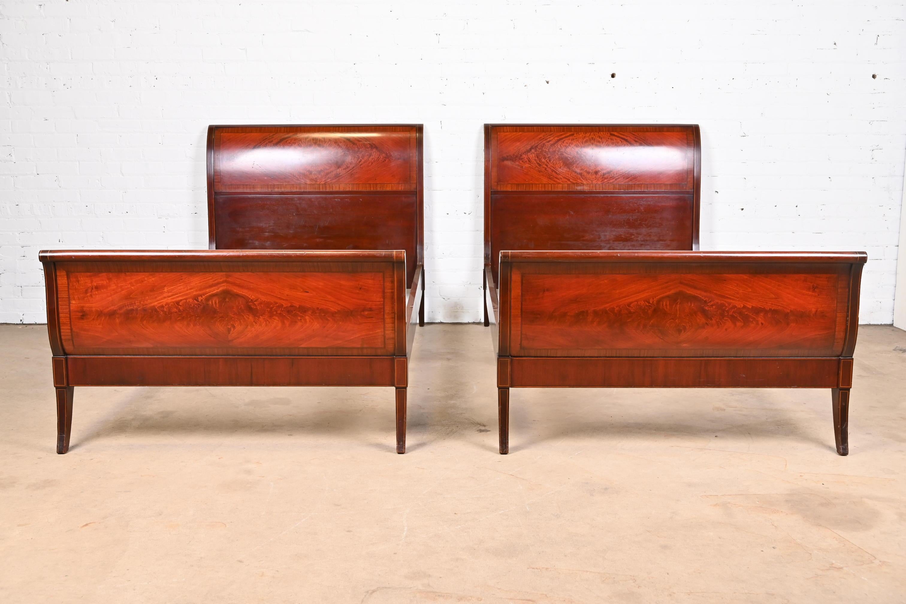 A gorgeous pair of Georgian style twin sleigh beds

Designed by Ralph Widdicomb for John Widdicomb Co.

USA, Circa 1940s

Stunning book-matched flame mahogany, with satinwood string inlay.

Measures: 41.75