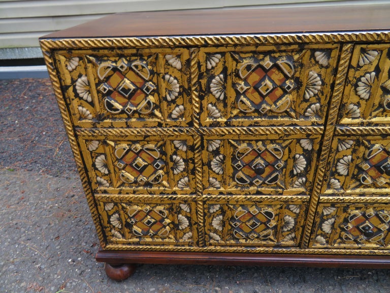Lovely John Widdicomb mahogany gold gilt 3 drawer/2 doors Mediterranean style petite credenza. Item features bun feet, gold gilt decorated drawer and door fronts, solid wood construction, beautiful wood grain, finished back and original stamp. There