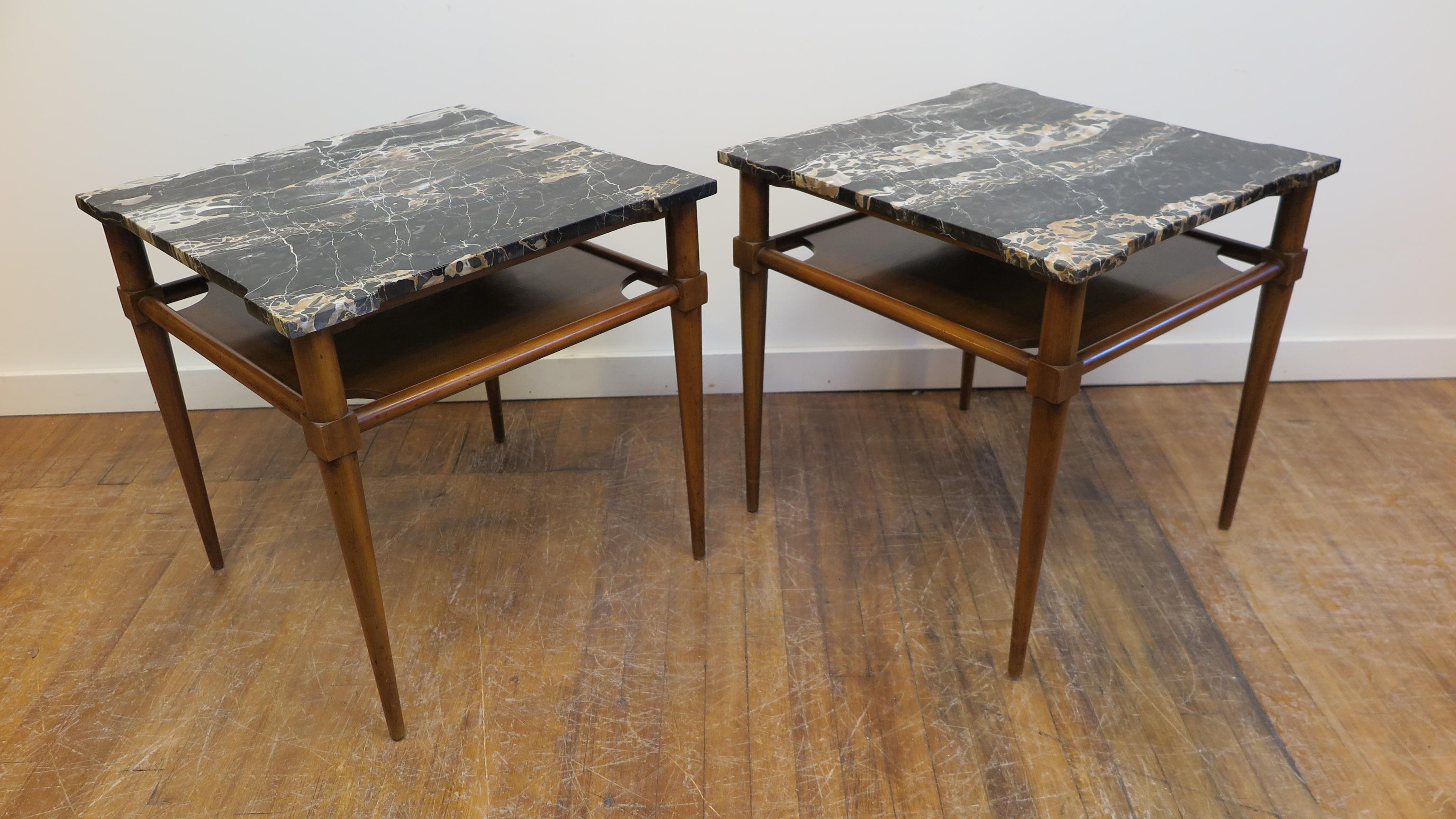 A pair of marble-top side tables manufactured by John Widicomb attributed to T. H. Robsjohn Gibbings. Italian black marble cut having enlarged emphasized corners, placed on top of stiletto style legs in a signature style of T. H. Robsjohn Gibbings,