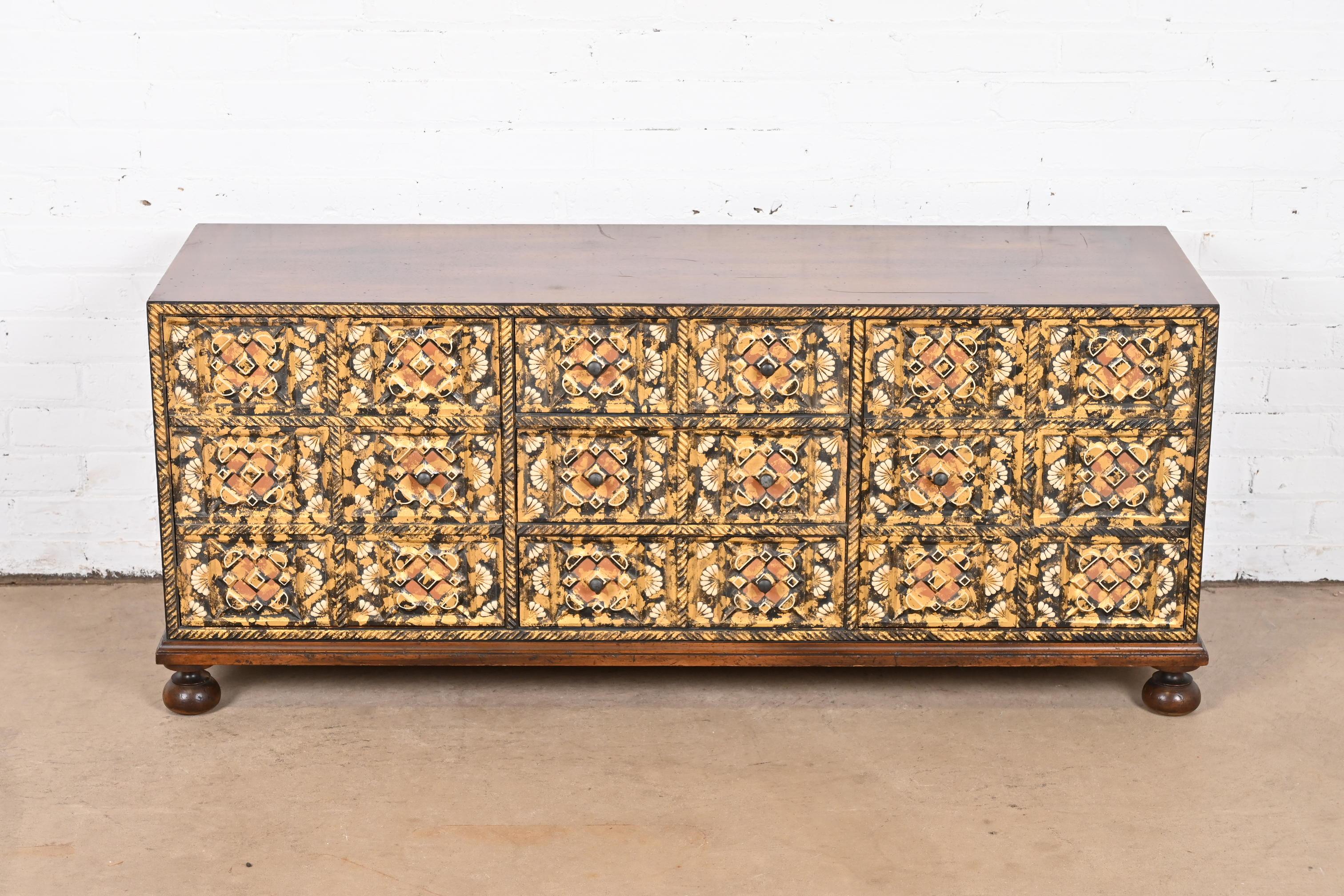 A gorgeous mid-century Mediterranean style low dresser or credenza

By John Widdicomb

USA, 1960s

Mahogany case, with intricately carved hand-painted and gold gilt mosaic style front.

Measures: 54