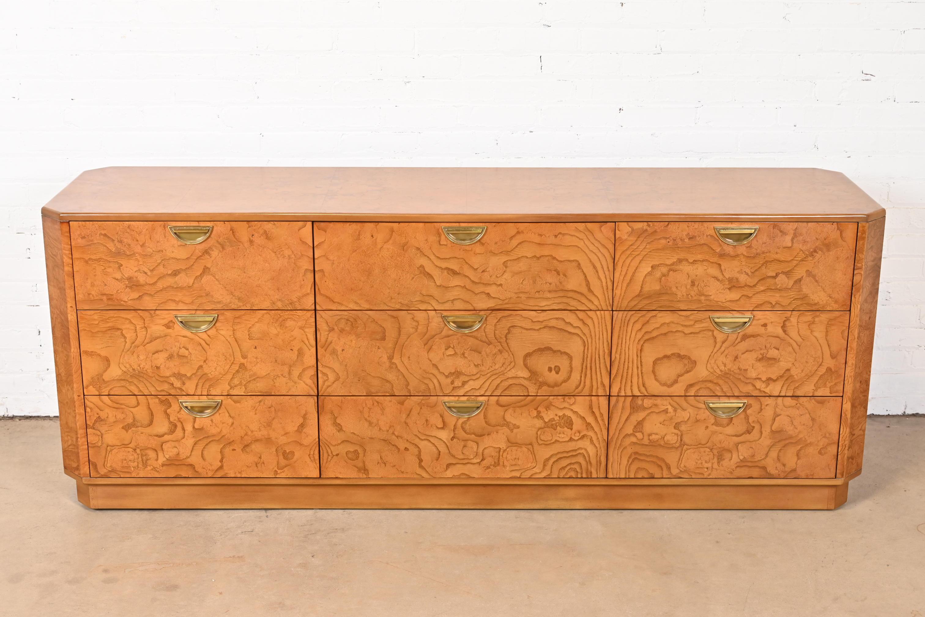 An exceptional mid-century modern Hollywood Regency triple dresser or credenza

By John Widdicomb

USA, Circa 1970s

Gorgeous burl wood, with original brass hardware.

Measures: 76.63