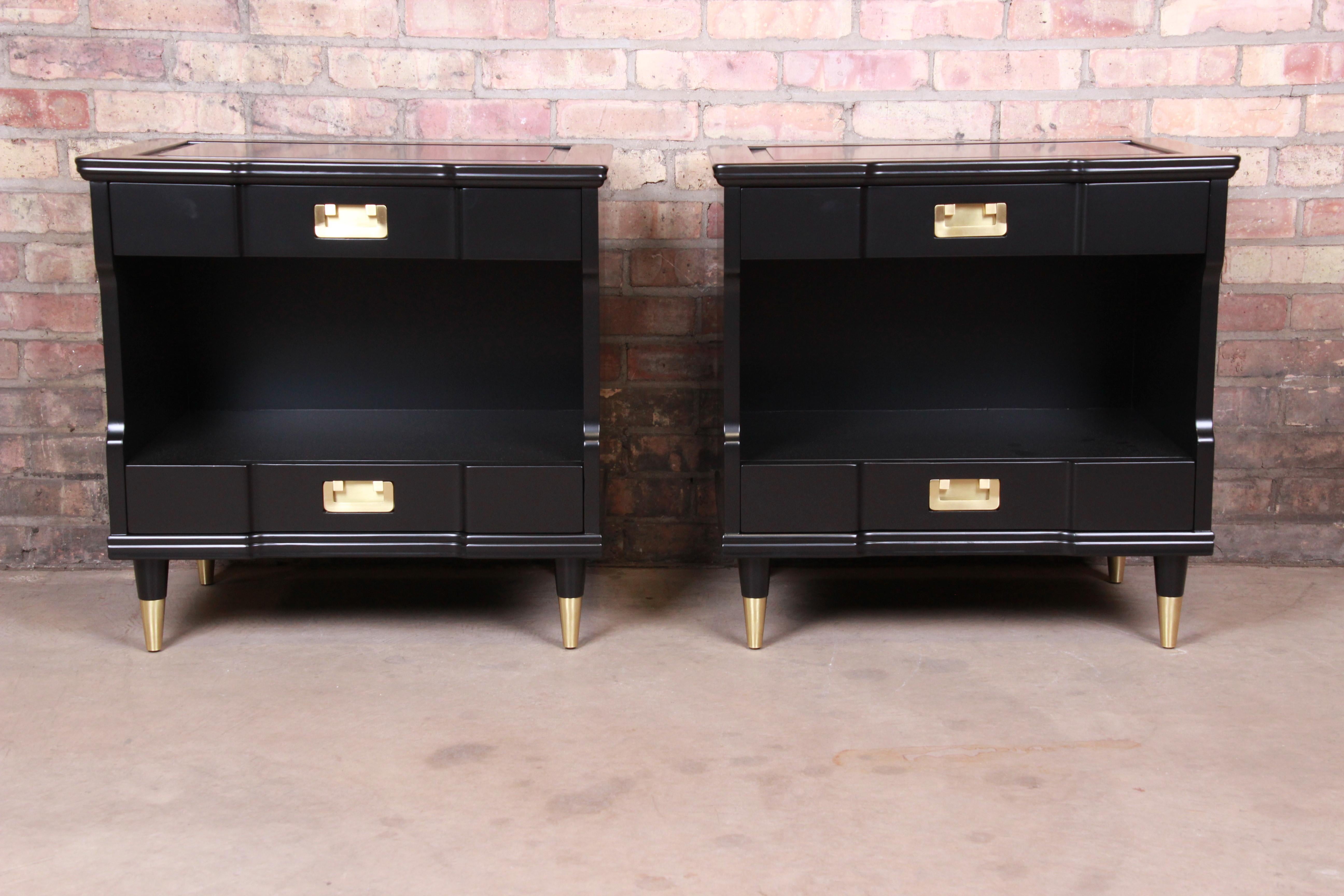 An exceptional pair of Mid-Century Modern Hollywood Regency nightstands

By John Widdicomb

USA, 1950s

Black lacquered solid cherry, with original brass hardware and brass-capped tapered feet.

Measures: 25.13