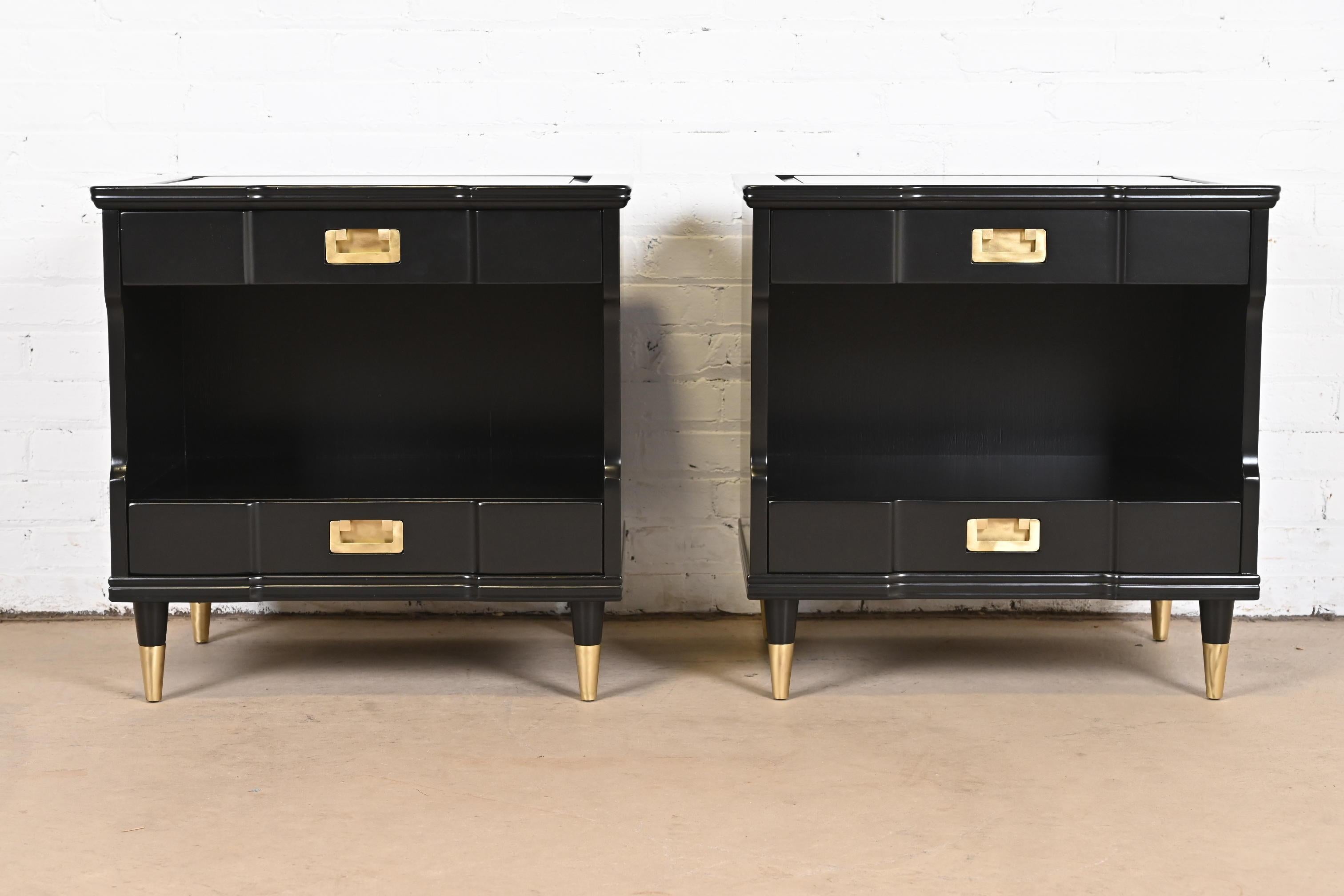 An exceptional pair of Mid-Century Modern Hollywood Regency Campaign style nightstands

By John Widdicomb

USA, circa 1960s

Black lacquered cherry wood, with original brass hardware and brass-capped tapered feet.

Measures: 25