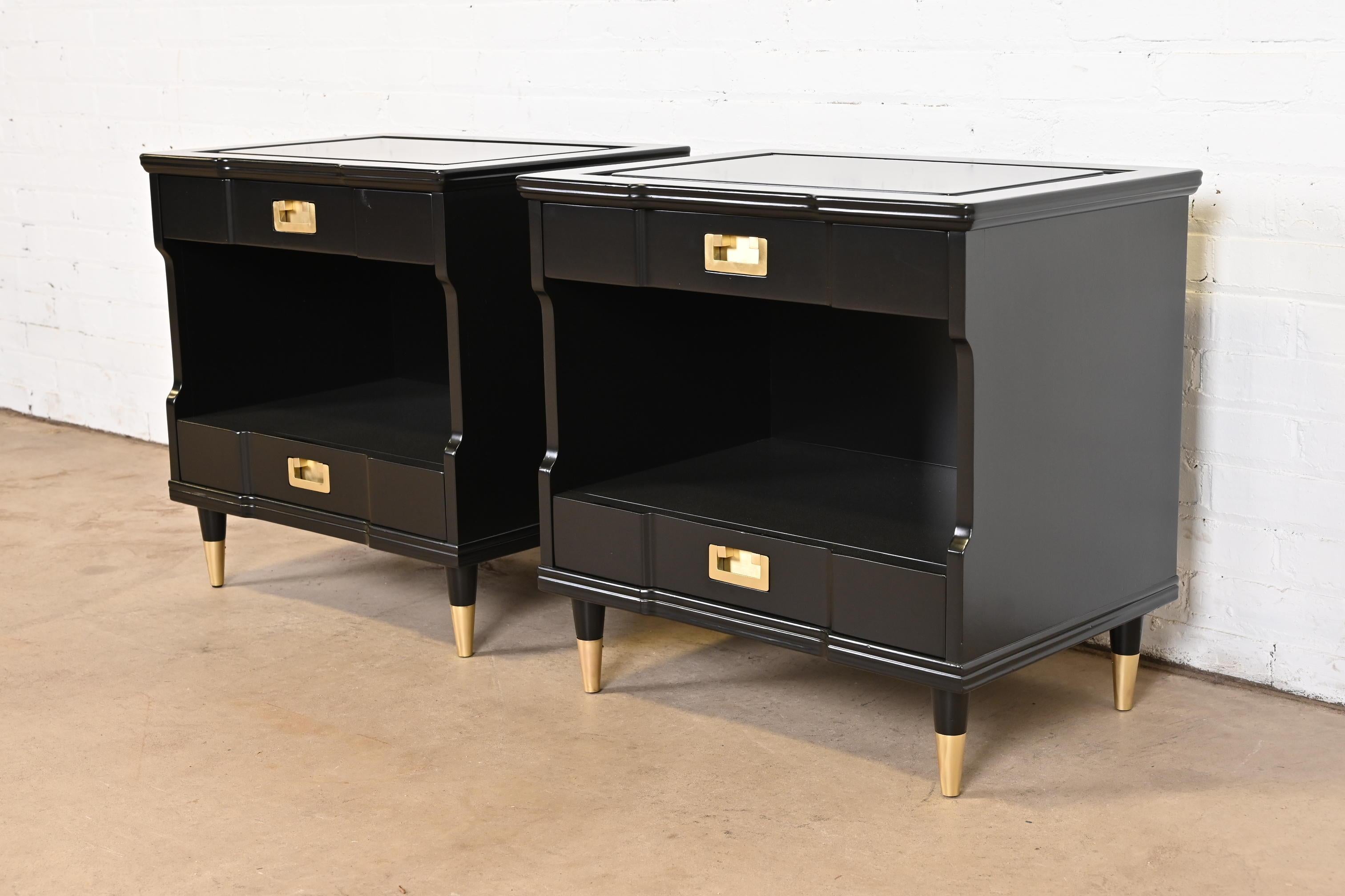An exceptional pair of mid-century modern Hollywood Regency Campaign style nightstands

By John Widdicomb

USA, Circa 1960s

Black lacquered solid cherry wood, with original brass hardware and brass-capped tapered feet.

Measures: 25