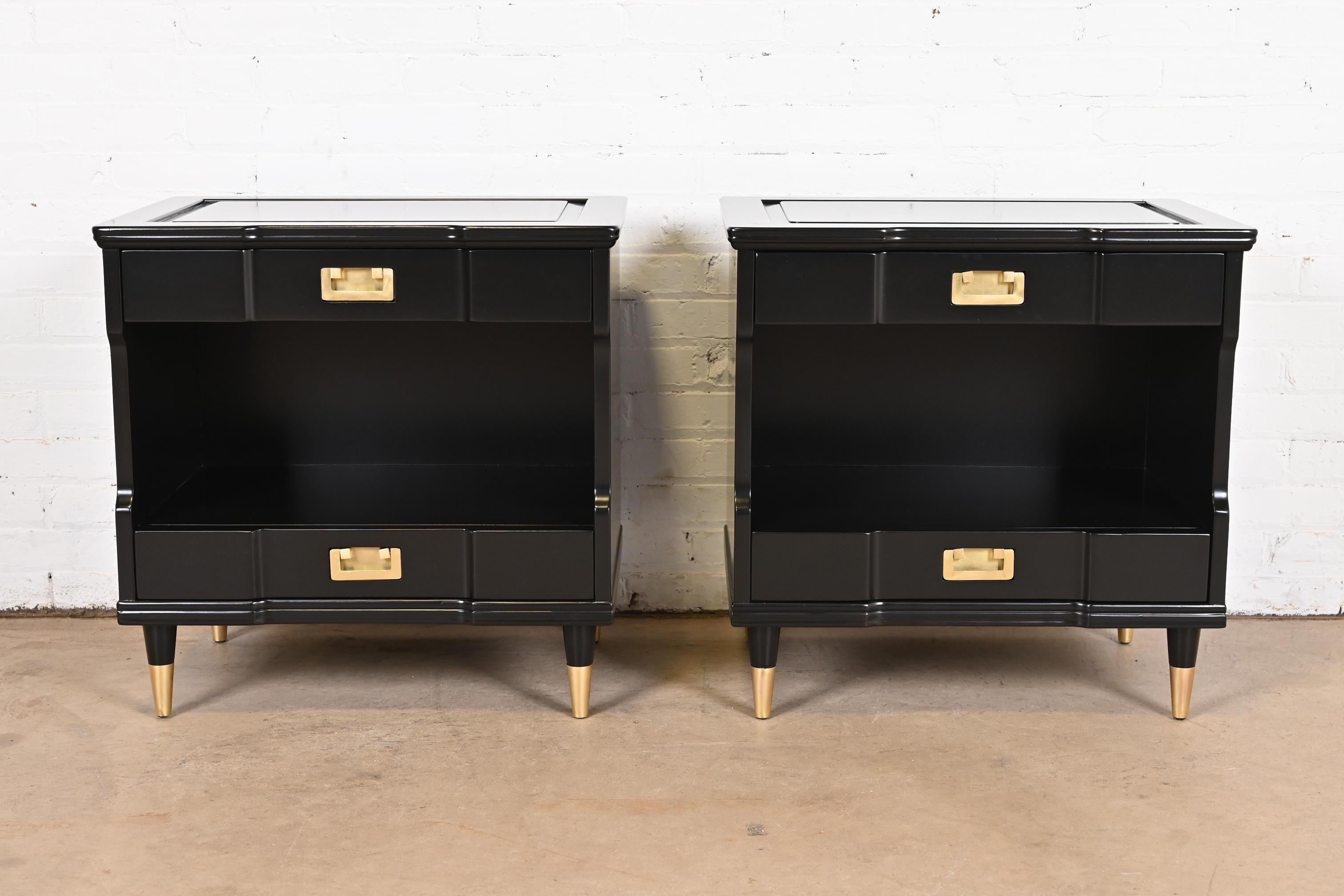 An exceptional pair of mid-century modern Hollywood Regency nightstands

By John Widdicomb

USA, 1950s

Black lacquered solid cherry wood, with original brass hardware and brass-capped tapered feet.

Measures: 25